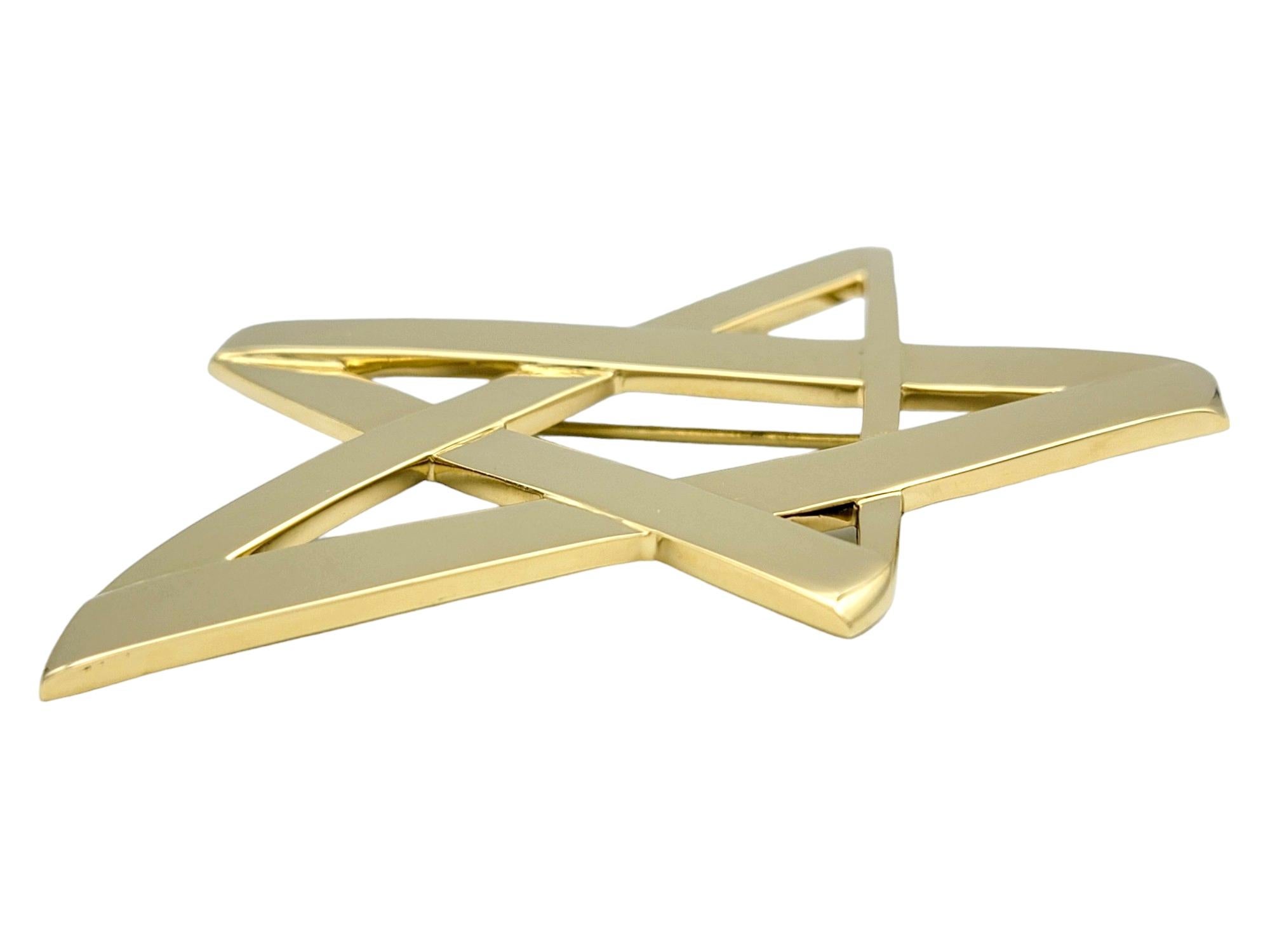 This gorgeous Tiffany & Co. Paloma Picasso asymmetrical star brooch is a captivating piece of jewelry that exudes charm. Crafted in 18 karat yellow gold, this brooch showcases Paloma Picasso's signature design aesthetic, characterized by bold and