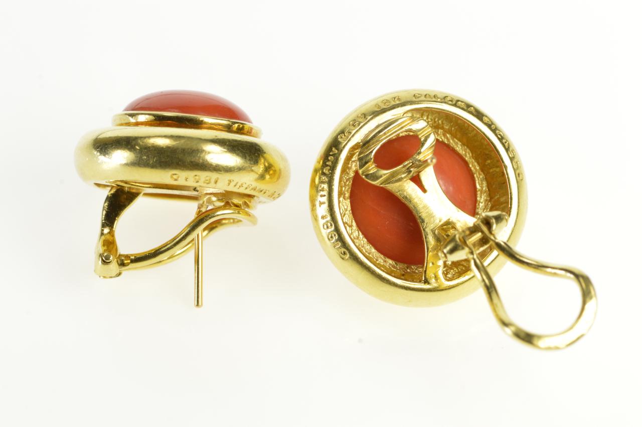 This exquisite design by Paloma Picasso for Tiffany & Co. is truly one of the classics. It features one of the most ancient gems used in jewelry, cabochon cut coral, set in 18 karat gold with secure, French clip backs, a total weight of 21 grams and