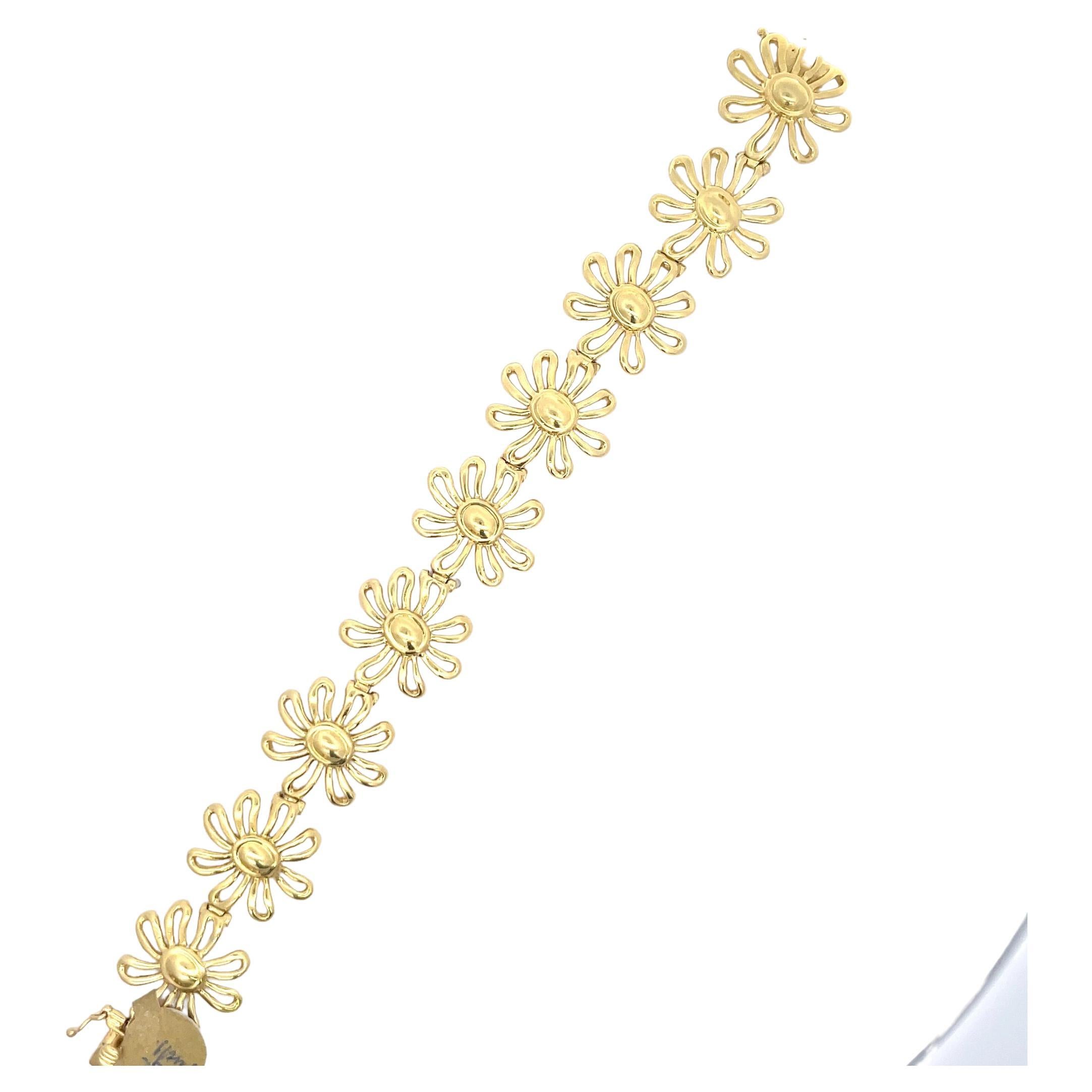 Tiffany & Co. Paloma Picasso bracelet featuring 9 Daisy flowers weighing 34.6 Grams in 18 Karat Yellow Gold.
Very Feminine! 