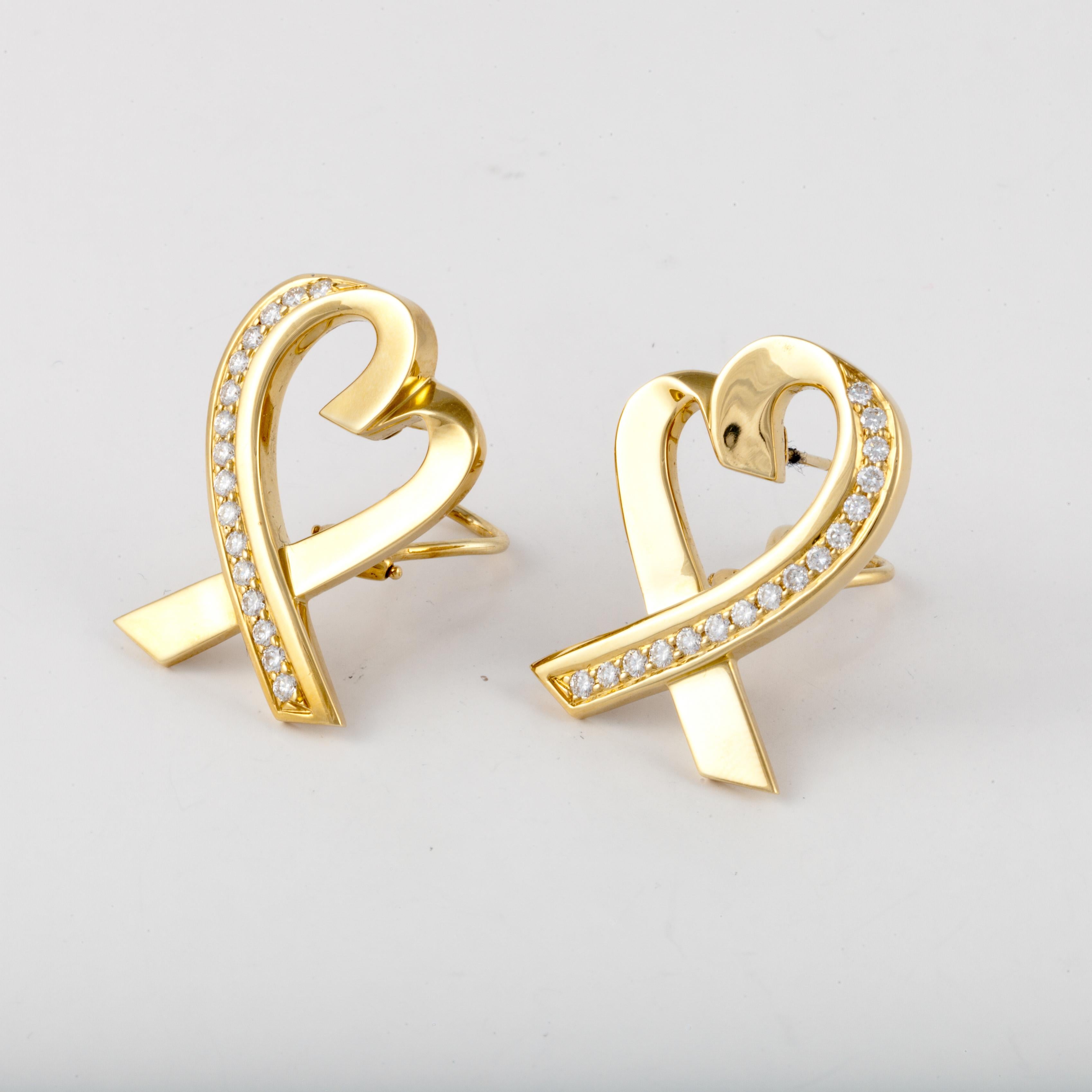 Tiffany & Co. Paloma Picasso 18K yellow gold heart earrings accented with round diamonds.  Total diamond carat weight is 1.25; F-G color and VVS-VS clarity.  They measure 1 1/4 inches by 7/8 inches.  