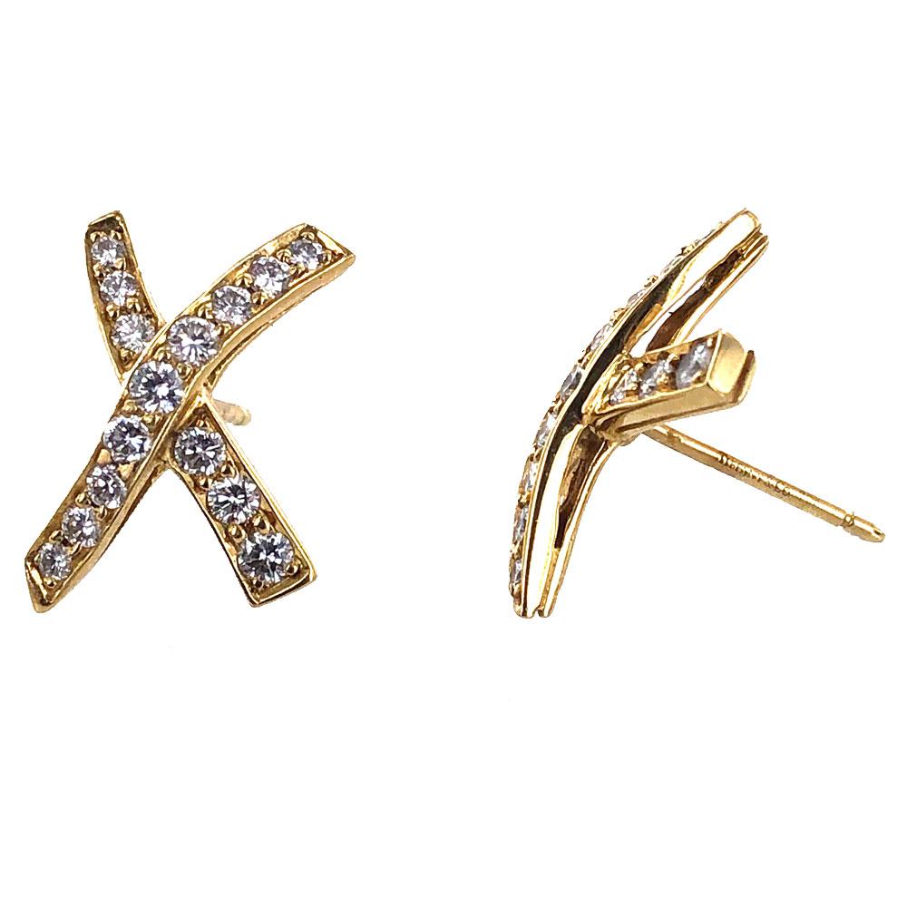 Tiffany & Co. Paloma Picasso Diamond X Kiss Stud Earrings. The diamond X earrings feature approximately .60 carat total weight of round brilliant cut diamonds graded F color and VS clarity. The earrings measure approximately .40 x .50 inches, and