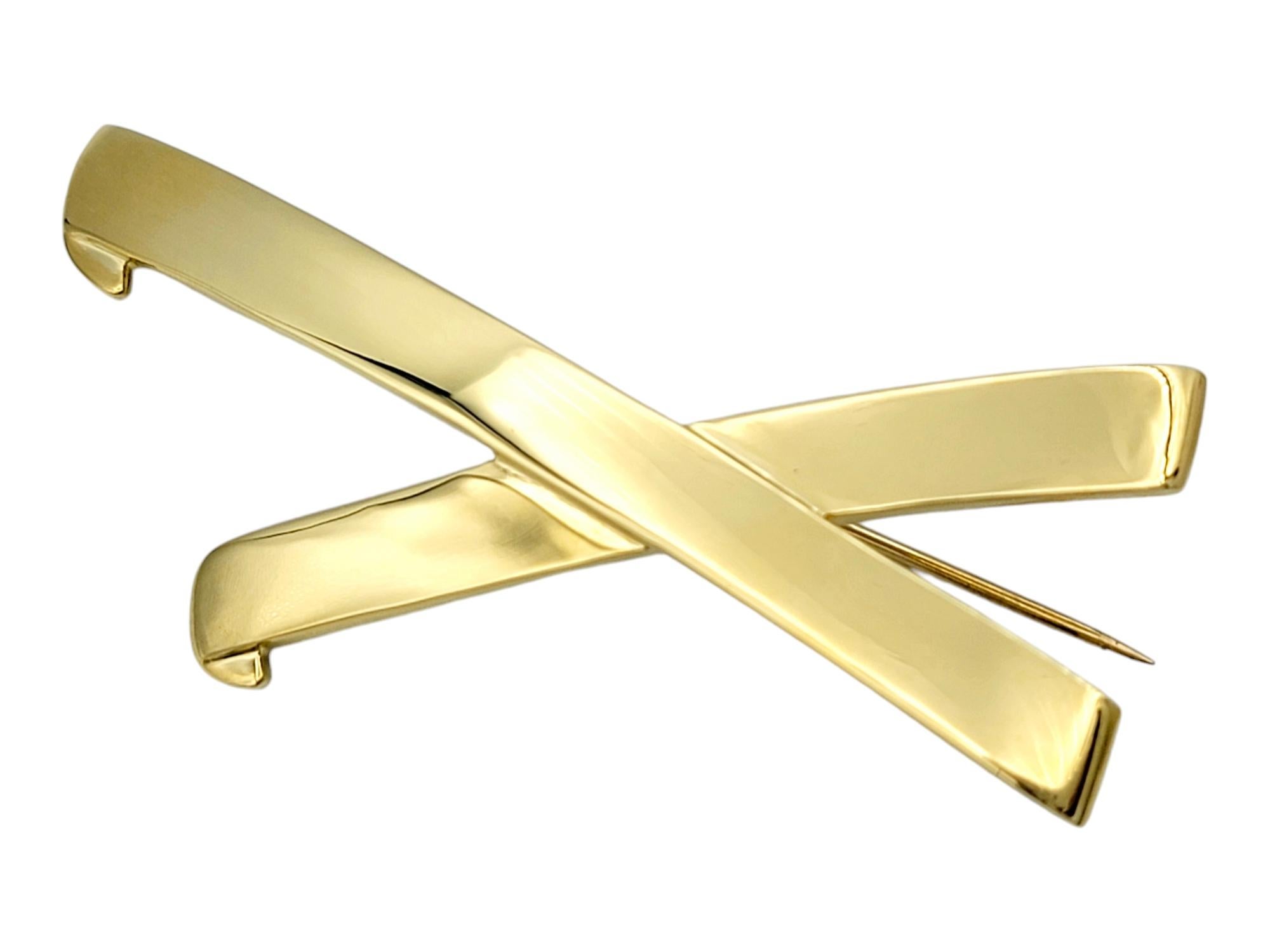 Discover the epitome of timeless elegance with this Tiffany & Co. Graffiti X brooch, designed by the iconic Paloma Picasso. Expertly crafted in lustrous 18 karat yellow gold, this piece radiates sophistication and versatility. Its bold yet graceful