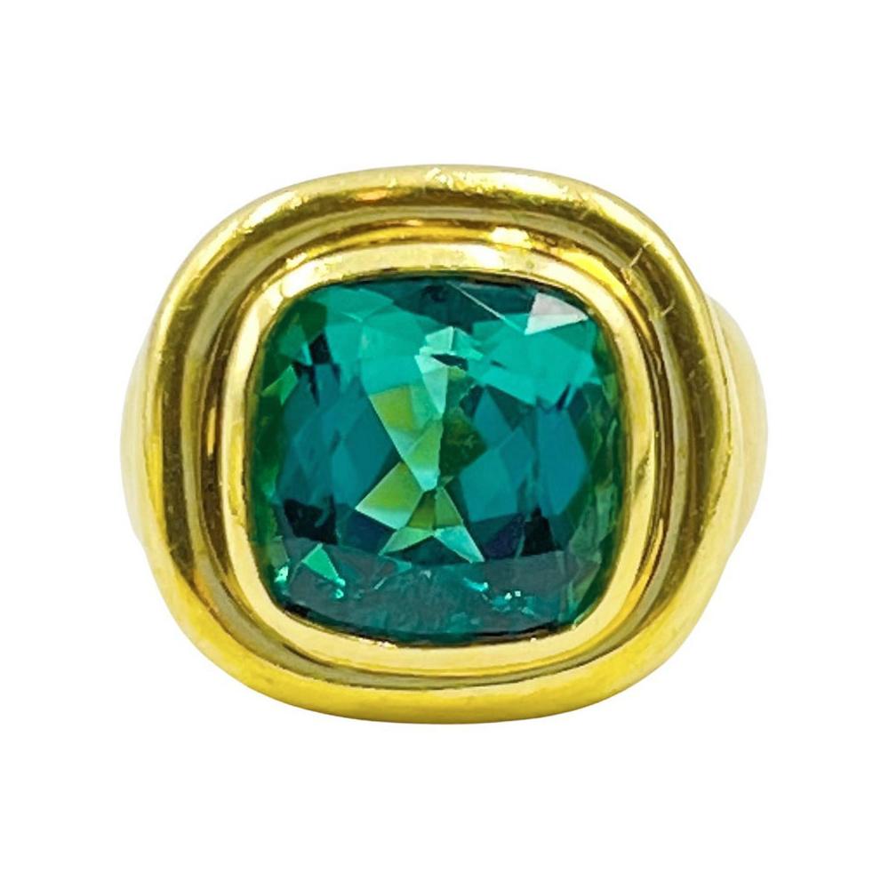 Simple and elegant design by Paloma Picasso for Tiffany & Co.  Bezel set with a 11.75mm cushion shape, faceted, natural mint green tourmaline weighing 6.33ct. Double border with a tapered polished gold shank.  Finger size 7.  Signed 