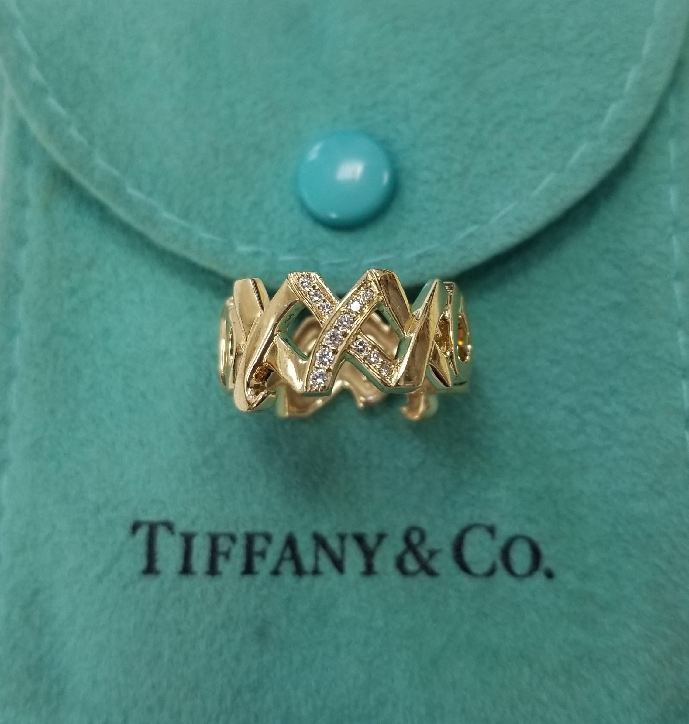 Specifications:
Pre-Owned (Great condition)
Brand: Tiffany & Co
Metal: 18K (Au 79.80-75%) Gold
Stones:  12 Diamonds .24 pts.
-round brilliant cut
Ring Size: 5.5
Width: 10.2 mm
Weight: 7.1 grams
Stamps: 