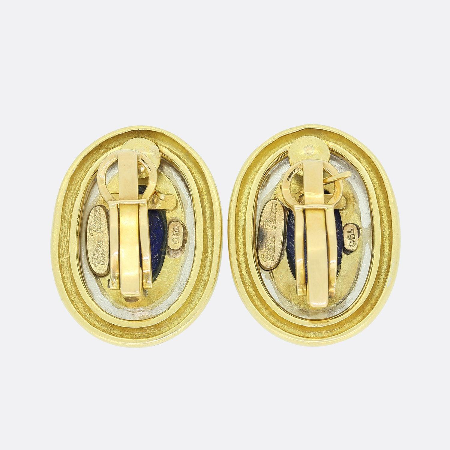 This is a pair of Tiffany & Co 18ct yellow gold earrings from the Paloma Picasso collection. Each earring plays host to a large oval piece of Lapis which has been set in an 18ct yellow gold setting with lever back fittings.

Condition: Used (Very