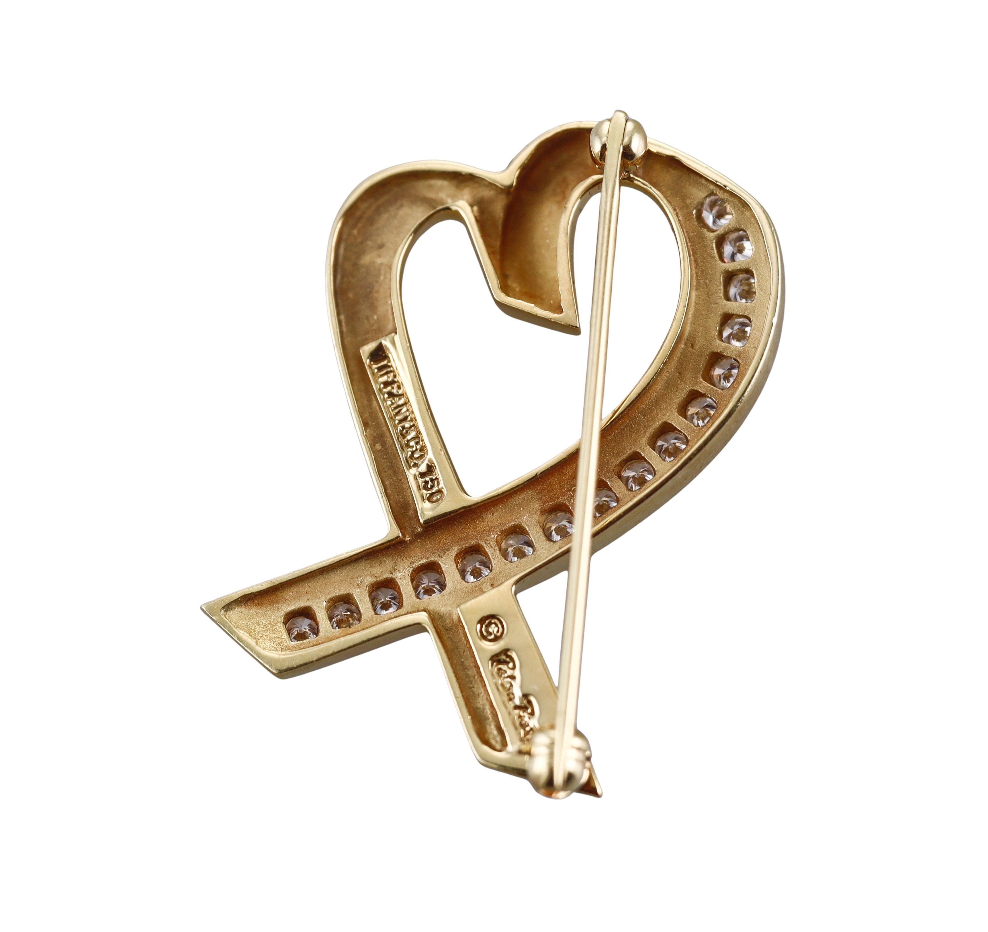 An 18k yellow gold Loving heart brooch, designed by Paloma Picasso for Tiffany & Co, adorned with approx. 0.48ctw G/VS diamonds.
Brooch measures 1 1/4