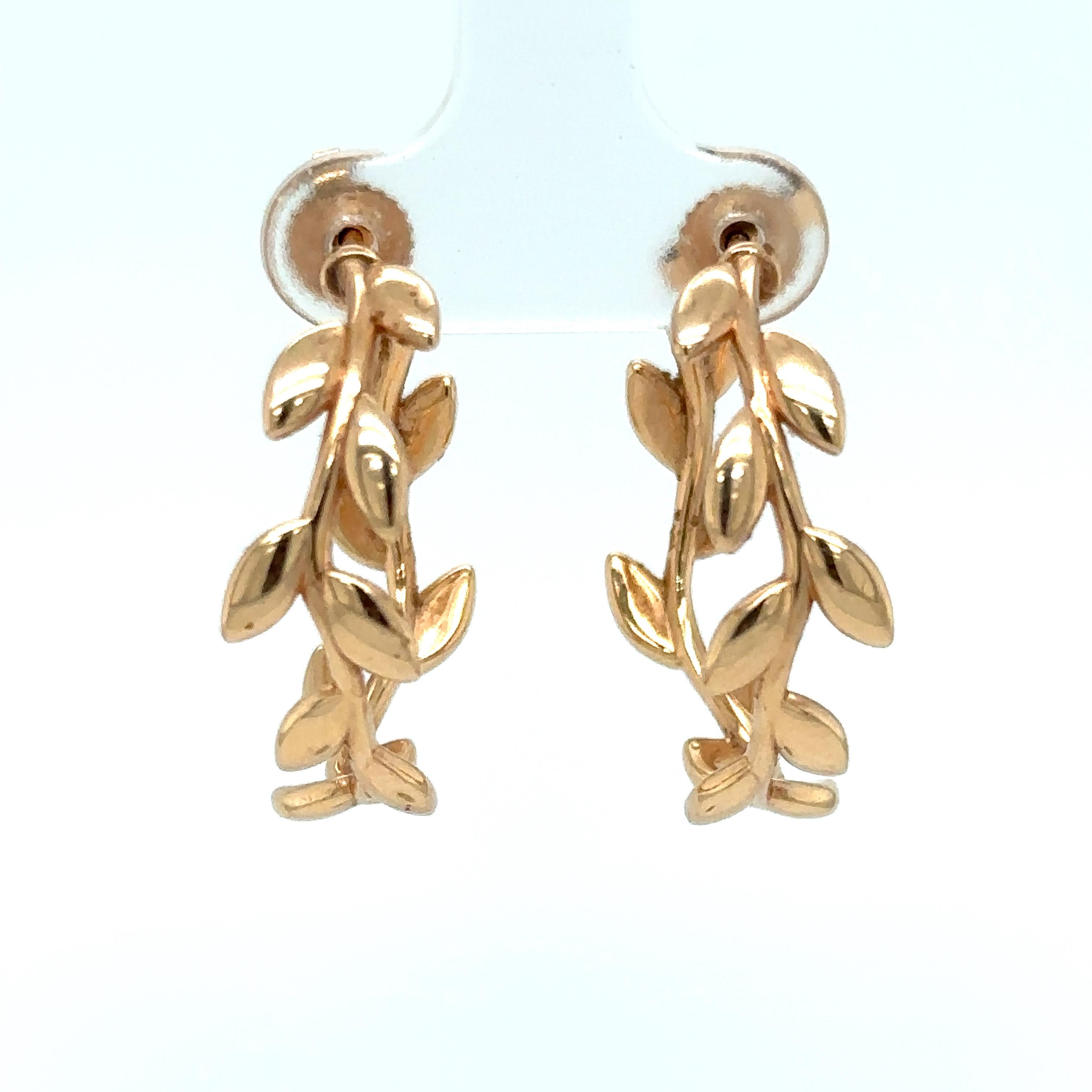 Item Details: These hoop earrings by Paloma Picasso for Tiffany & Co. have an olive leaf motif in an open hoop design. Crafted in 18 Karat Yellow Gold, they boast an impressive design! 

Circa: 2000s
Metal Type: 18 Karat Yellow Gold
Weight: 10.4