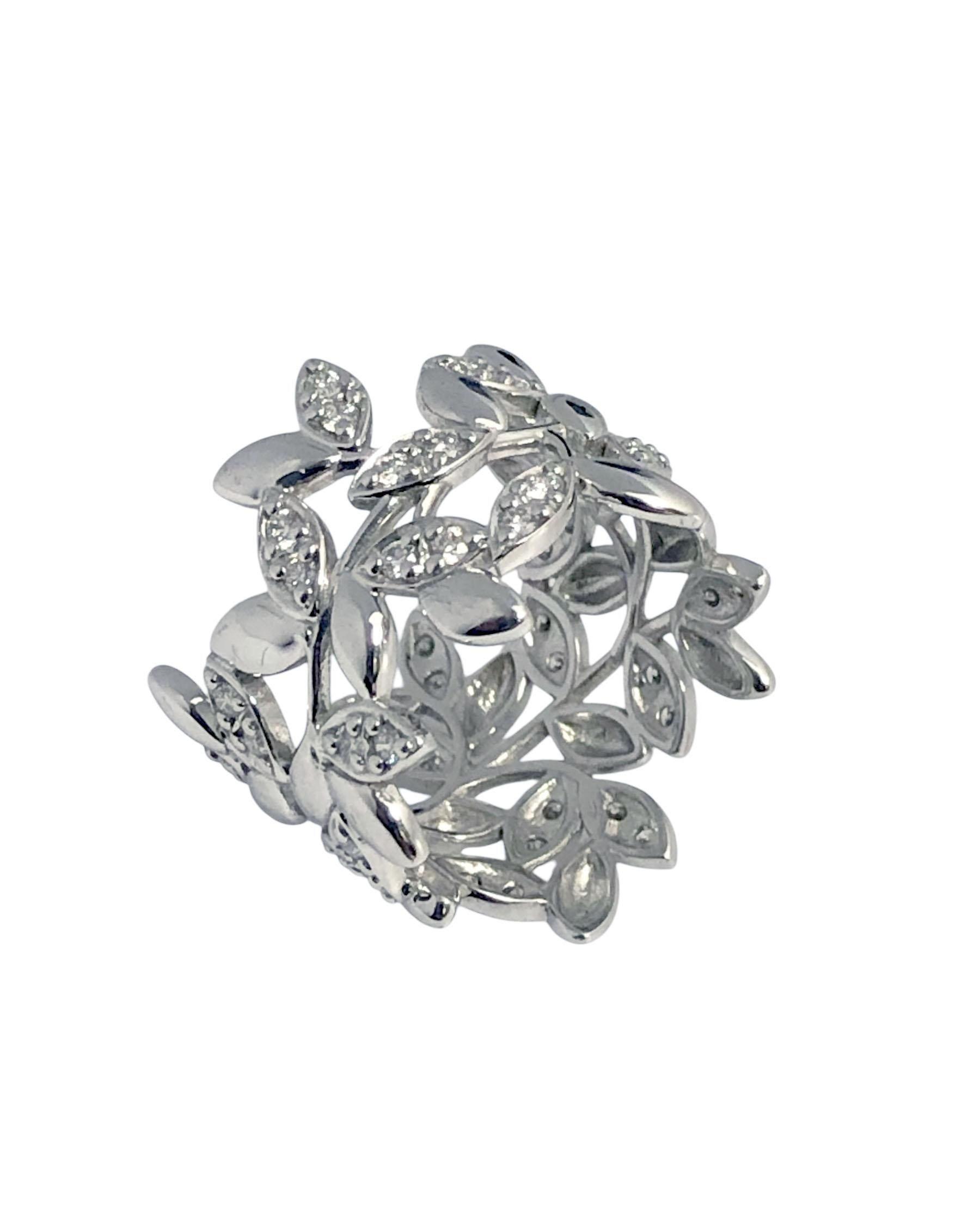 Circa 2000 Paloma Picasso for Tiffany & Company Olive Leaf collection 18k White Gold Band Ring, measuring 5/8 inch wide and a Finger size 6 1/2, set with Round Brilliant cut Diamonds totaling approximately .49 Carat. Comes in original Tiffany