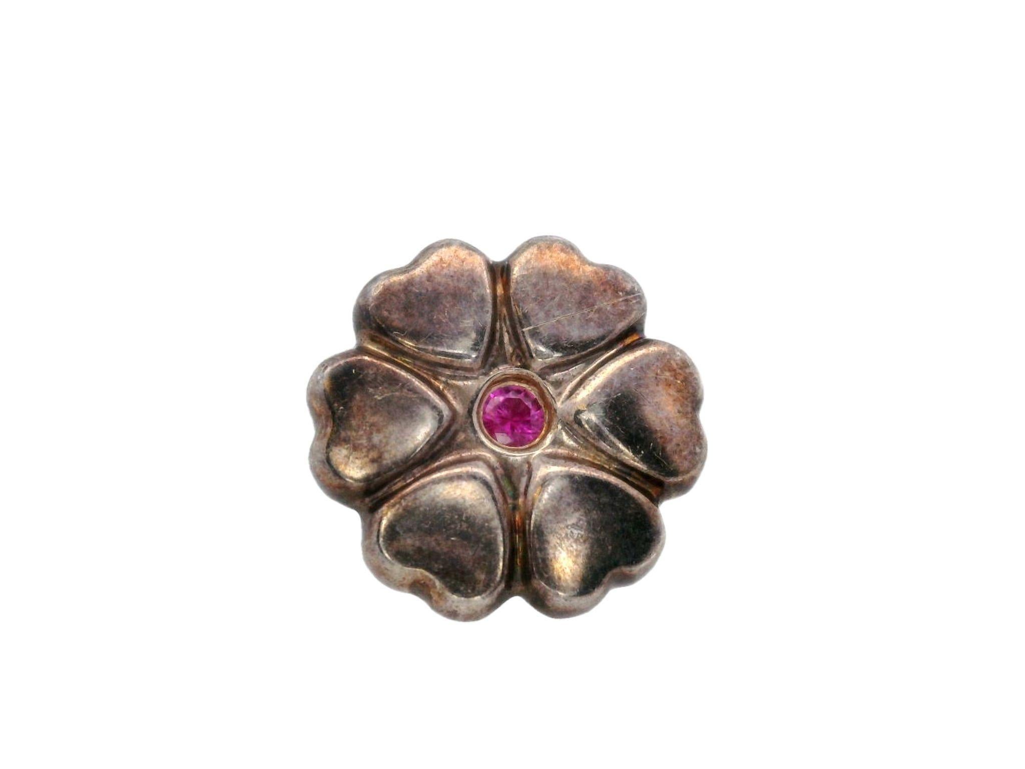 The Tiffany & Co. Paloma Picasso Pink Sapphire Heart Studs in Sterling Silver are a beautiful blend of elegance and modern style.

Designed by Paloma Picasso, these dainty earrings are crafted in sterling silver and feature a lovely floral pattern,