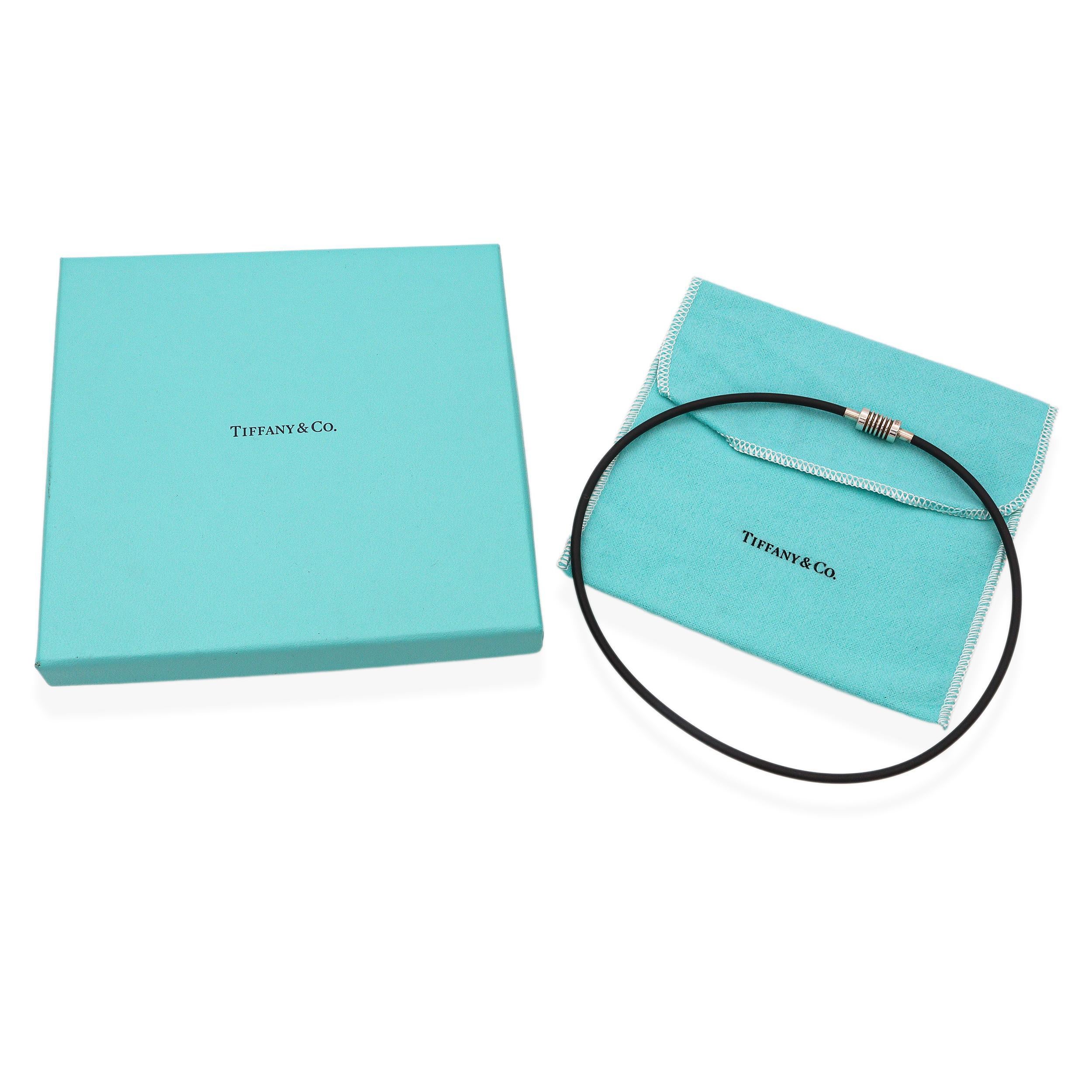 Tiffany & Co. Paloma Picasso Rubber Grove Necklace. This bold and modern necklace features Tiffany’s iconic design by Paloma Picasso, crafted from durable black rubber for a contemporary, edgy look. The flexible rubber links are accented with
