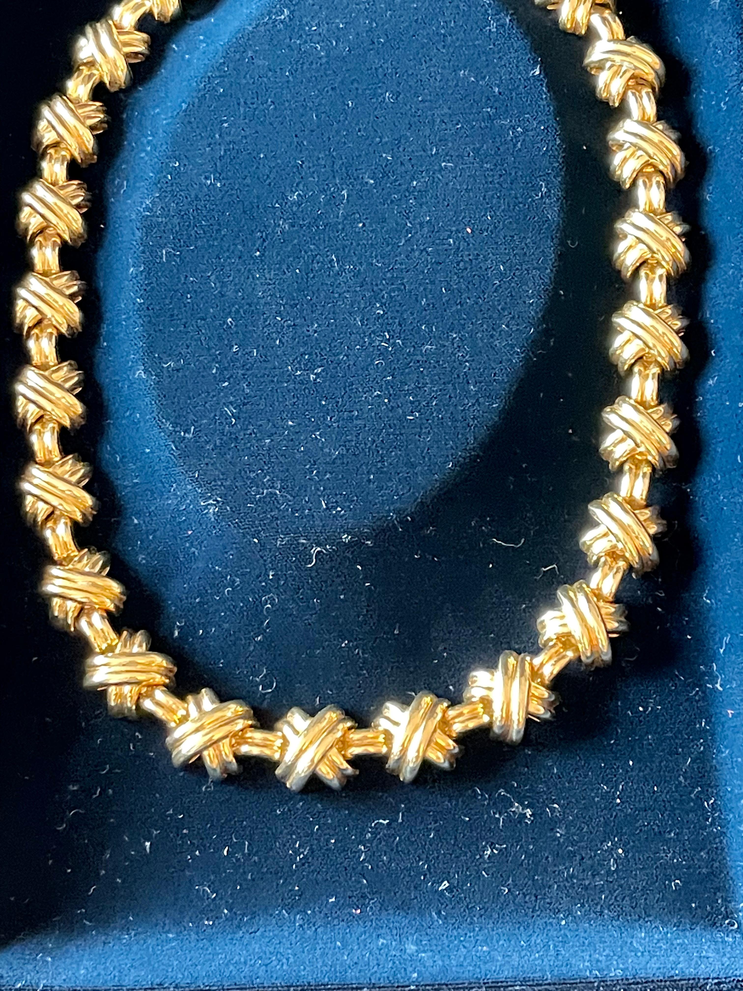 Paloma Picasso’s Signature X necklace and earrings from the Signature Collection. The bold x design is 18 K yellow Gold featuring polished surfaces and contemporary lines. 18 K yellow Gold Tiffany & Co necklace. A series of X links alternate with