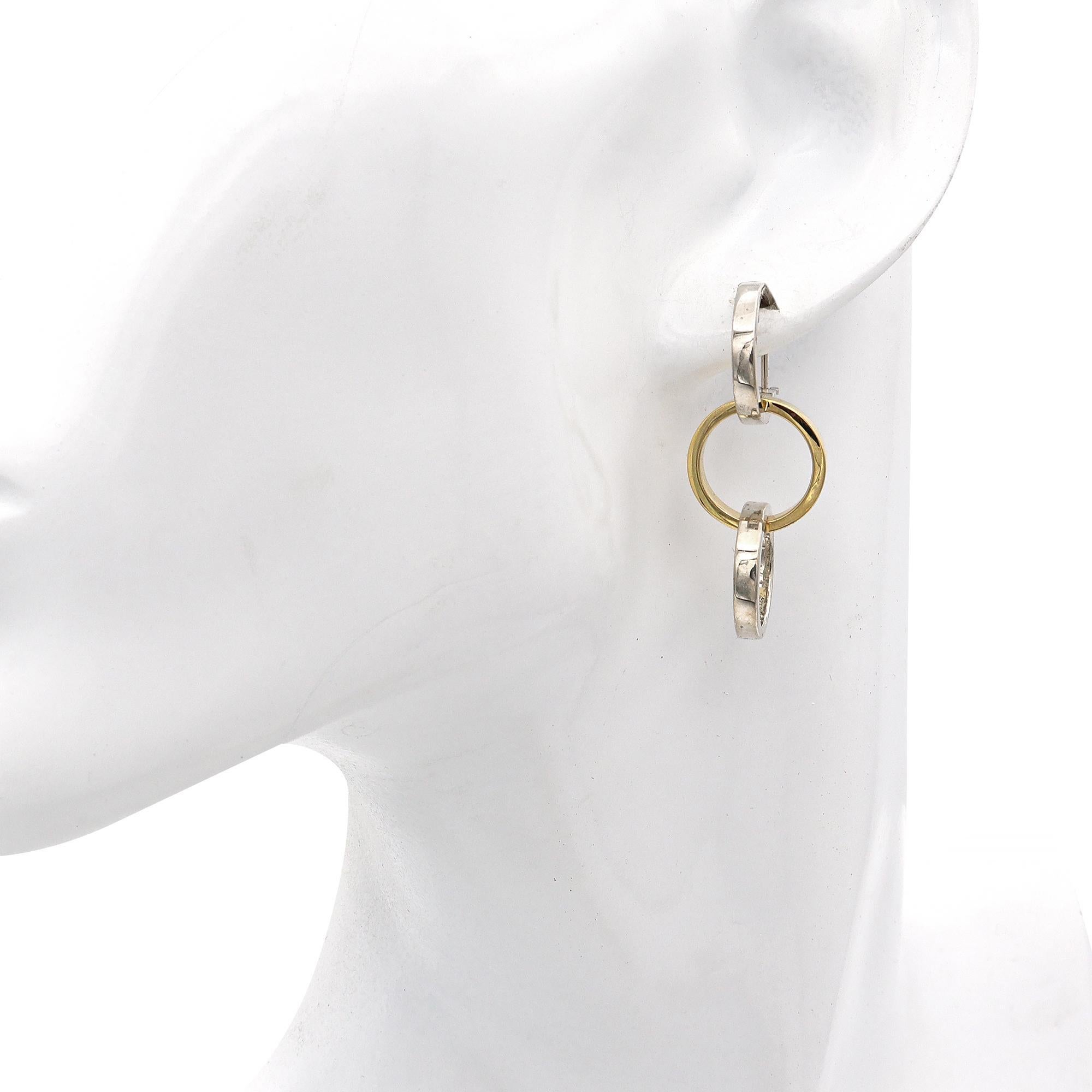 Elevate your jewelry collection with these elegant interlocking drop earrings from the iconic Tiffany & Co., designed by the legendary Paloma Picasso. Crafted from radiant sterling silver (.925) and warm 18k yellow gold, these earrings feature a