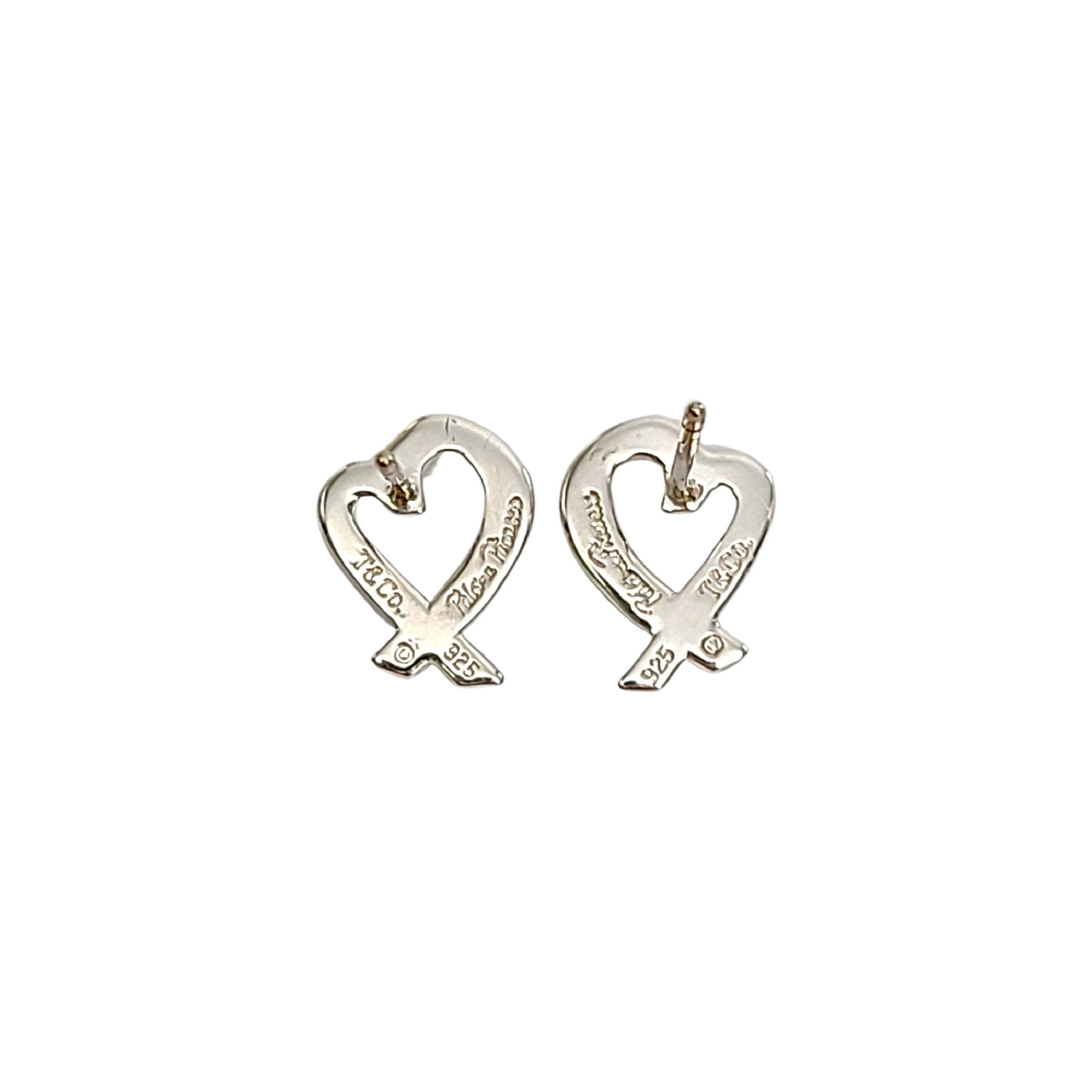 Tiffany & Co sterling silver Loving Heart earrings by Paloma Picasso.

Authentic Tiffany earrings featuring small open hearts. 1 earring back is NOT Tiffany. Tiffany box and pouch are not included.

Measures approx 10mm high, 8mm wide.

Weighs