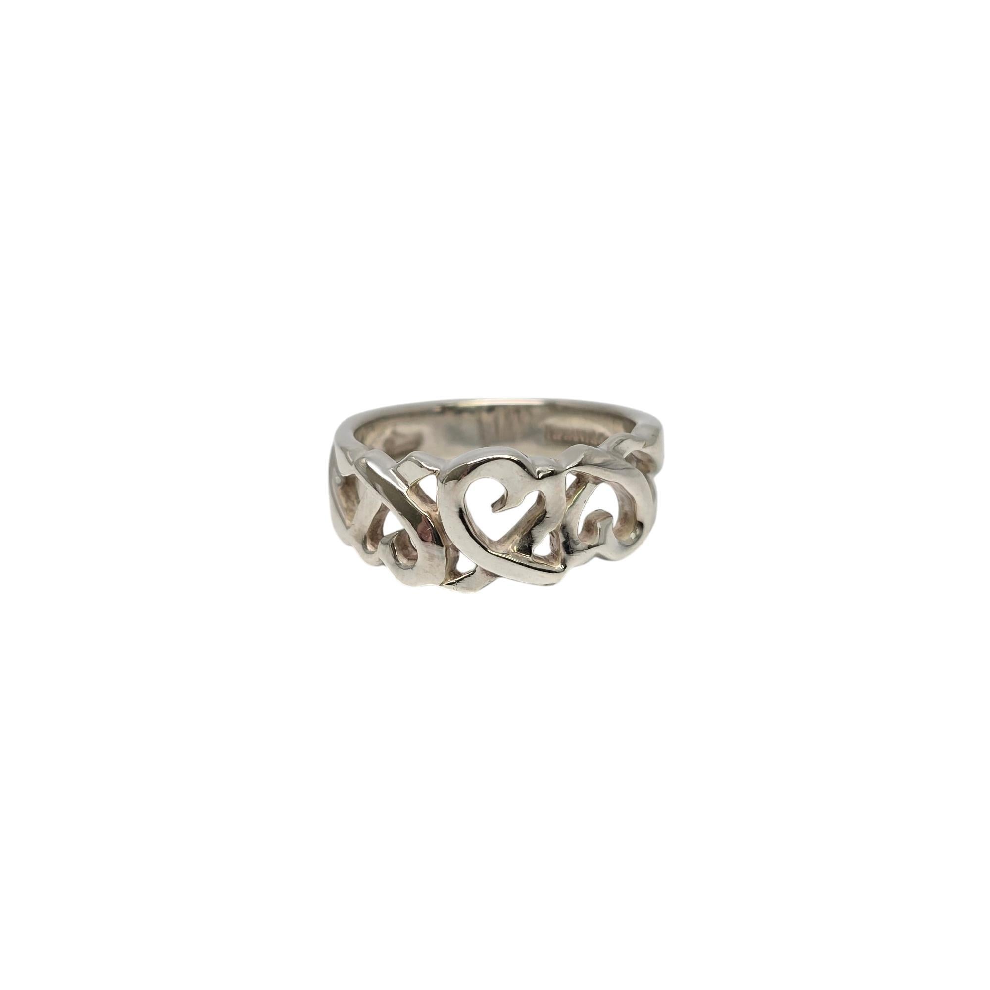 Sterling silver Loving Hearts ring by Paloma Picasso for Tiffany & Co.

Size 7

An original Paloma Picasso design, this iconic Loving Hearts band features open hearts across the front of the band. Tiffany & Co box and pouch are not