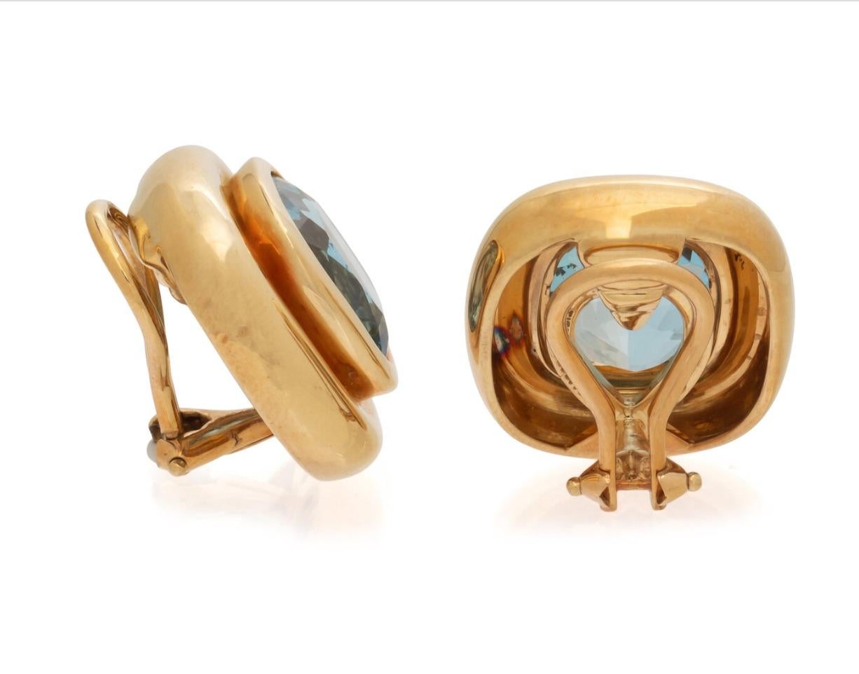 These fun and colorful Tiffany earrings designed by Paloma Picasso feature a bright cushion mixed cut aquamarine measuring approximately 12.85 x 10.60 x 7.60 mm carats. Mounted in 18 karat yellow gold, this rounded design is extremely wearable and