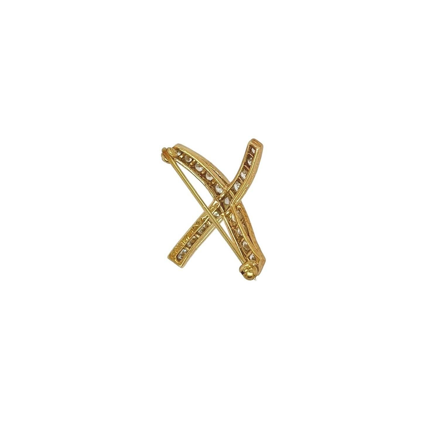 An 18 karat yellow gold and diamond brooch, Paloma Picasso, Tiffany & Co., circa 1984.  The “X Kiss” brooch designed as the letter x set with eighteen (18) round brilliant cut diamonds.  Total diamond weight approximately 1.22 carats.  Length