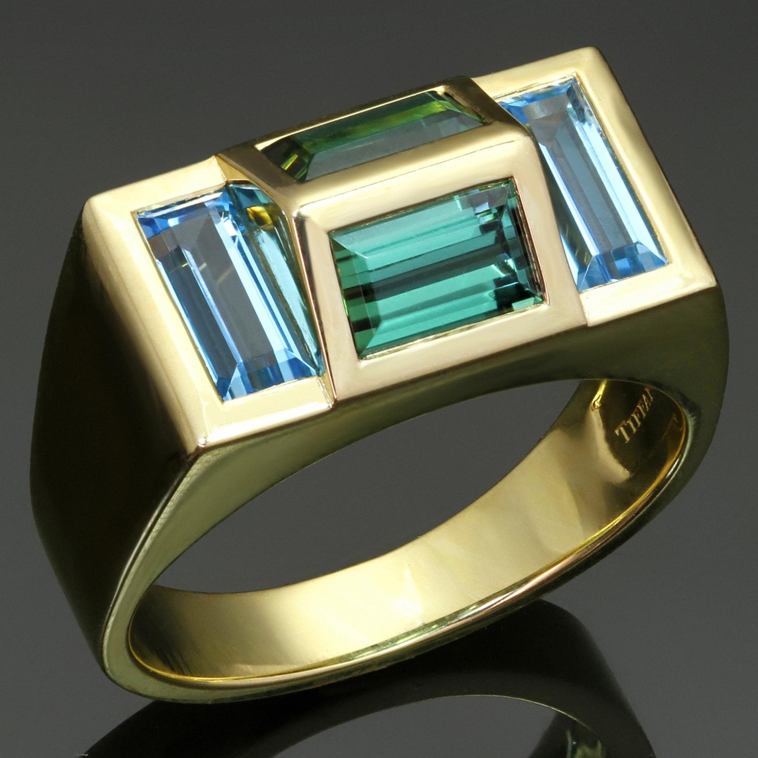This fabulous authentic Tiffany & Co. Paloma's Studio 4-stone ring is crafted in 18k yellow gold and set with a pair of blue topaz baguettes weighing an estimated 2.25 carats and a pair of green tourmaline baugettes weighting an estimated 2.80