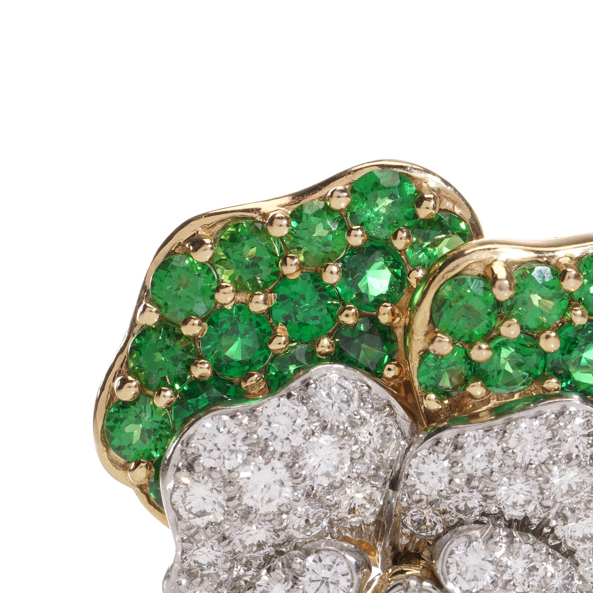 Embrace timeless elegance with this vintage Tiffany & Co. Pansy Brooch.
Made in circa 1960.
Crafted in 18kt yellow gold and platinum, adorned with brilliant cut tsavorite garnets, diamonds, and sapphires.

Signed and numbered for authenticity.