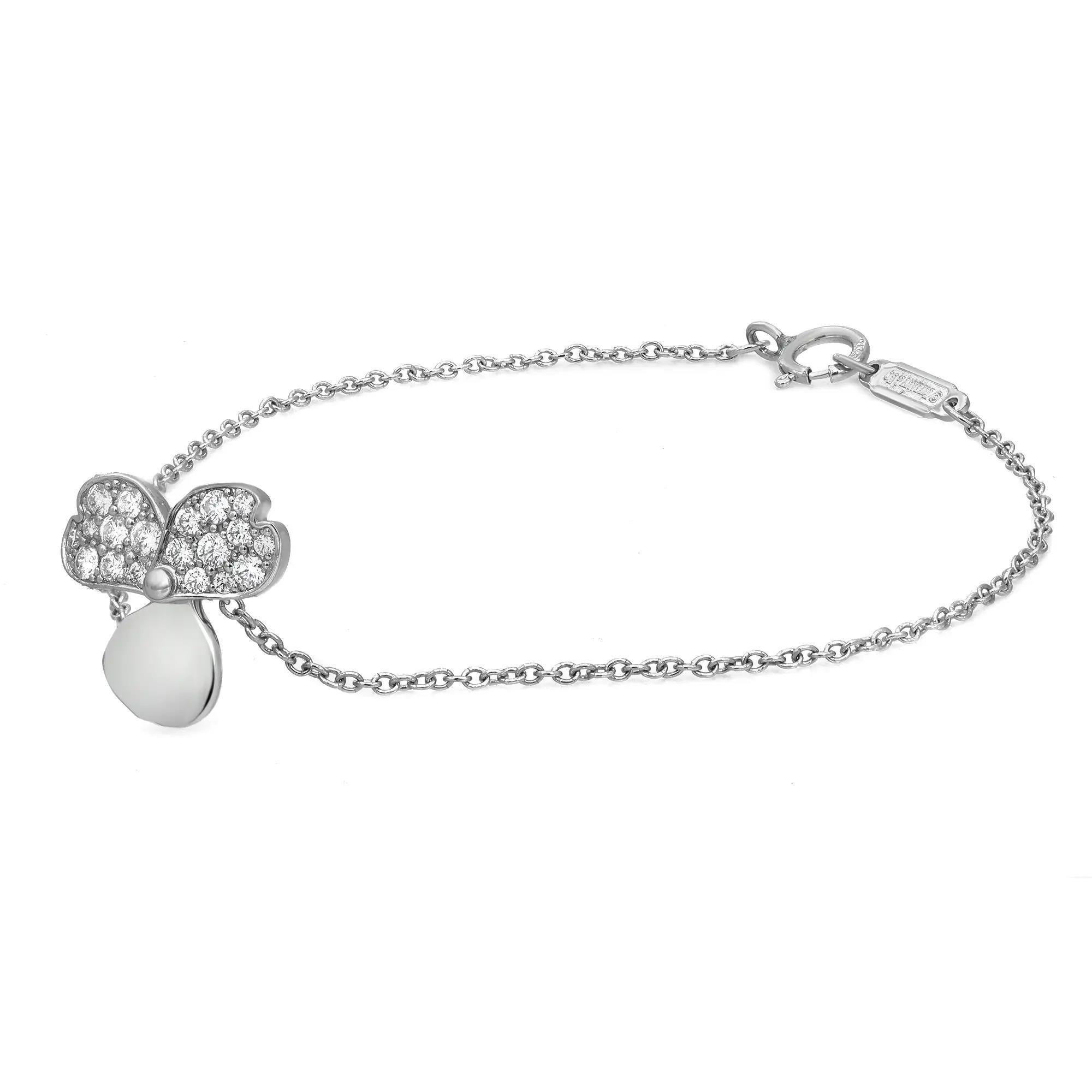 Sleek and modern Tiffany & Co. Paper Flowers diamond chain bracelet. Crafted in lustrous platinum. This bracelet features a center flower charm studded with round brilliant cut diamonds on two petals. Total diamond weight: 0.17 carat. Bracelet