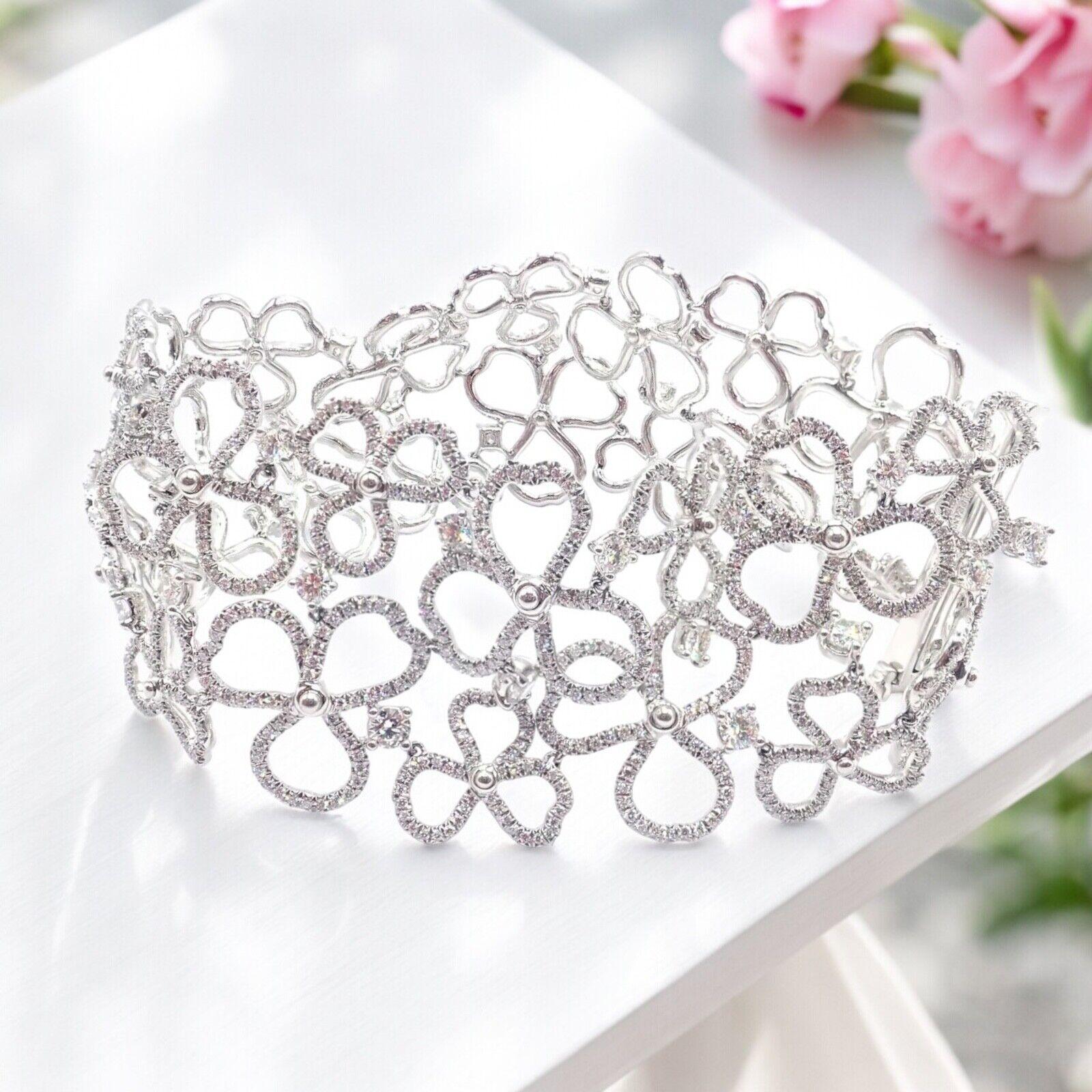Platinum Diamond Paper Flowers Wide Bracelet by Tiffany & Co.  
The Tiffany & Co Paper Flowers Bracelet is a stunning piece crafted in platinum. It features an intricate floral design encrusted with dazzling diamonds. 
This wide bracelet embodies