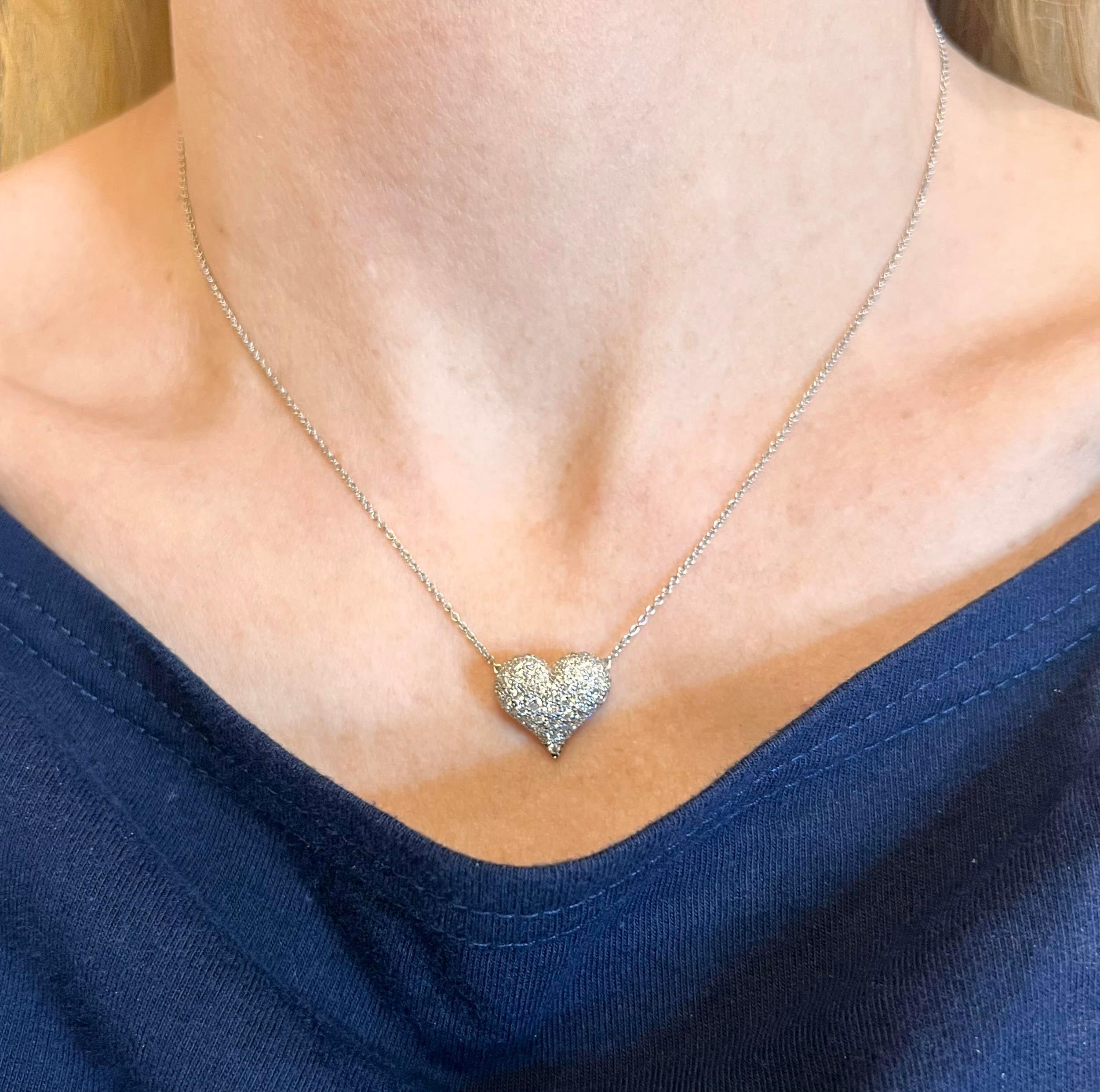 Tiffany & Co. platinum puffed heart pendant pave-set with 63 round brilliant-cut diamonds totaling 1.04 carats (E-F color and VVS-VS clarity).  Delicate curb link neck chain measuring 16.5