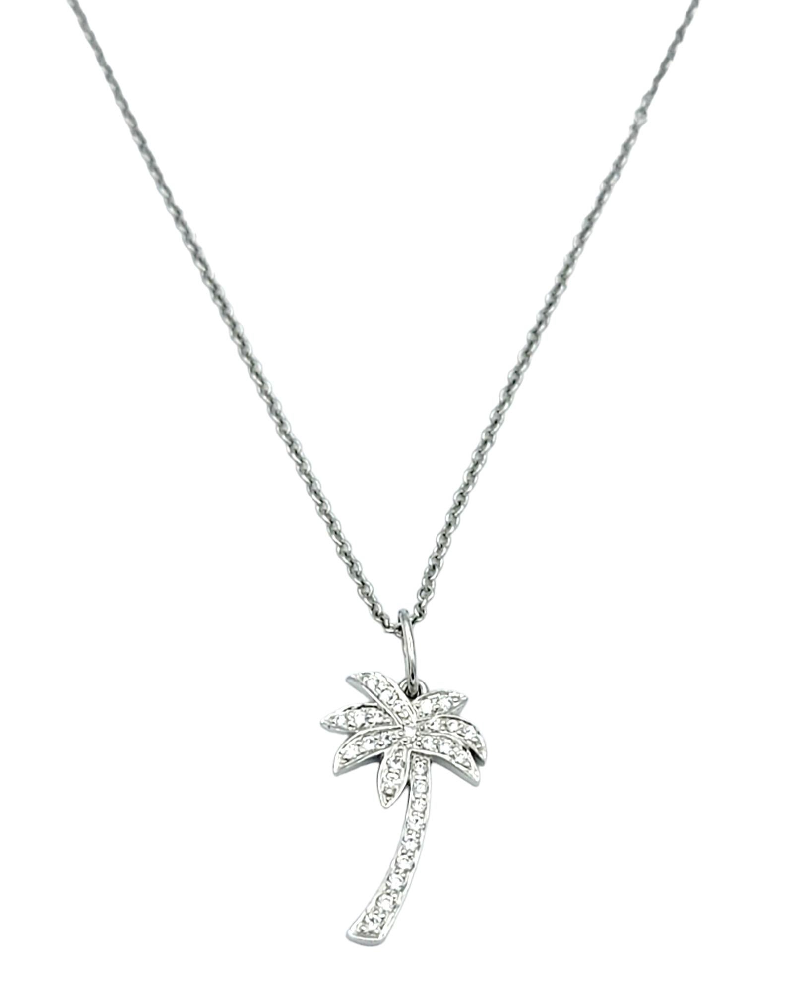 This Tiffany & Co. pendant necklace, crafted in platinum, is a sublime expression of refined luxury. The pendant features a small palm tree intricately adorned with diamonds, creating a dazzling and whimsical representation of nature. The meticulous