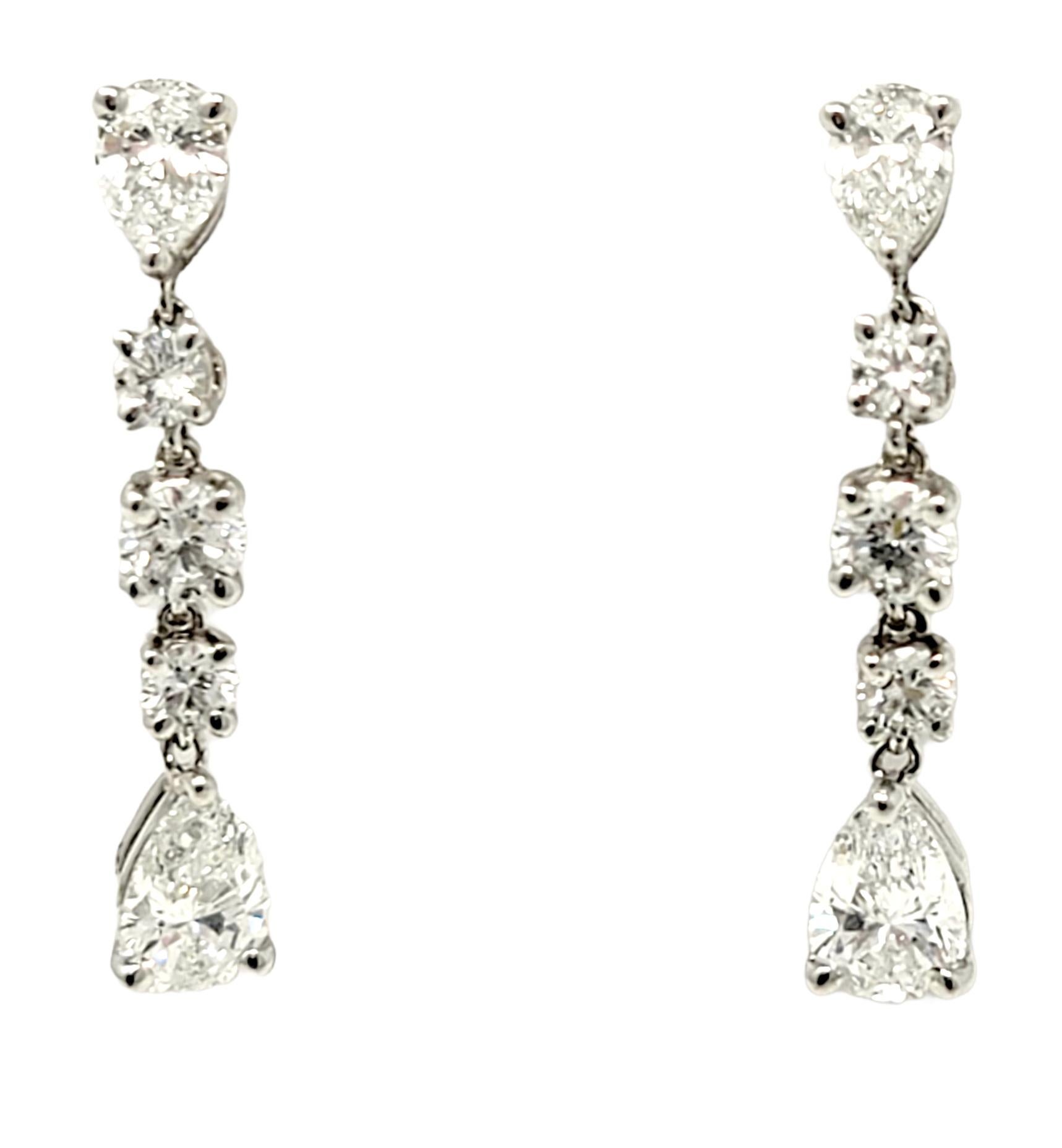 These gorgeous Tiffany & Co. diamond dangle earrings offer major sparkle and a timeless design. The gentle movement and length reflects the diamonds from all angles, making them twinkle beautifully on the ear. These designer beauties feature a total