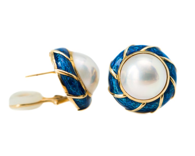 1980s Tiffany and Co. Pearl Earrings - 18 Karat Yellow Gold, Enamel, Pearls

Features: 
Large Pearl Centers
Cobalt Blue Enamel accented with 18 Karat Gold
18 Karat Yellow Gold Backs and Setting
Hinged Lever Backs with Comfort Insert
Pearls have a