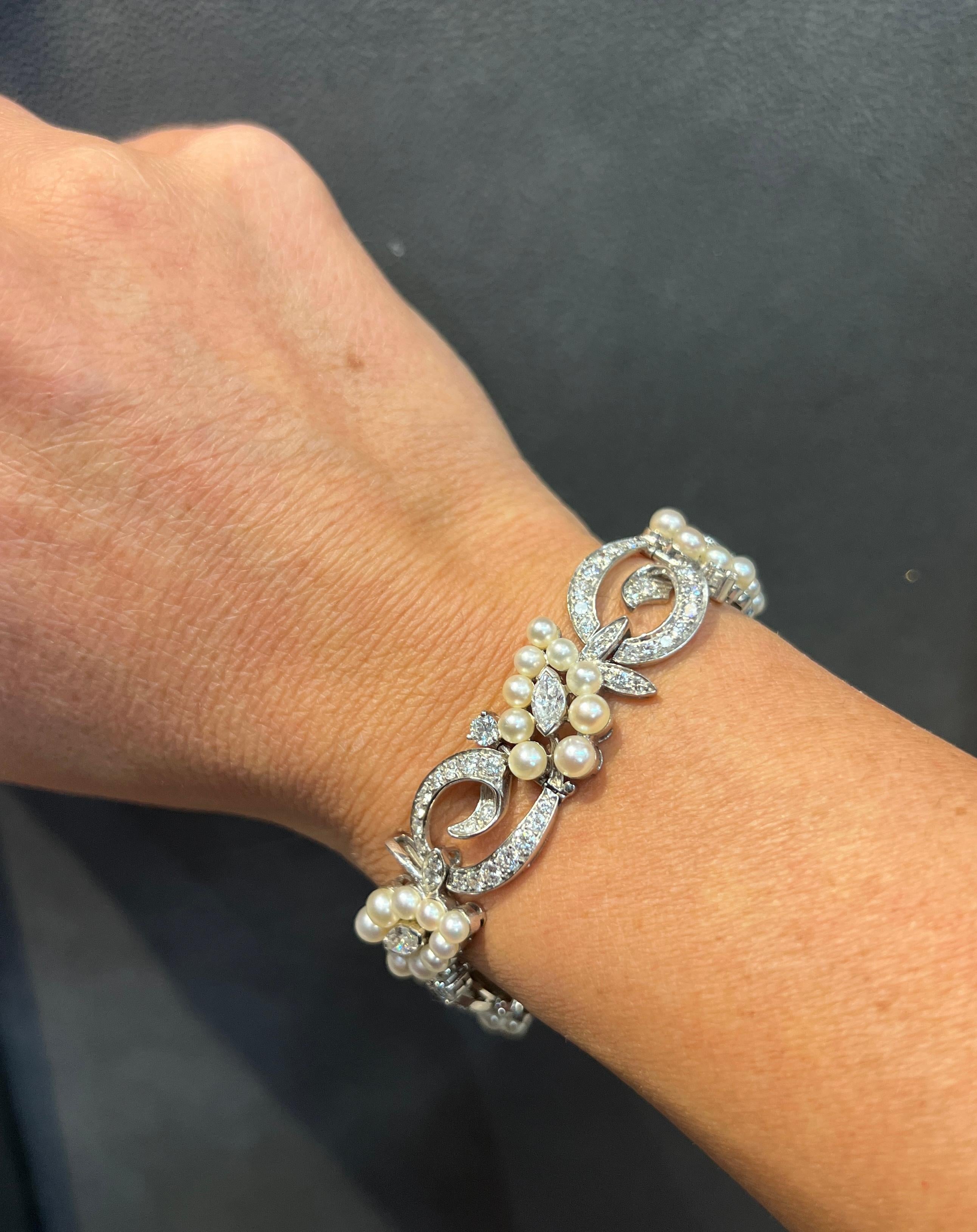 

This bracelet features pearls, round & marquise cut diamonds forming a floral motif.

Made circa 1950

Measurements: 7