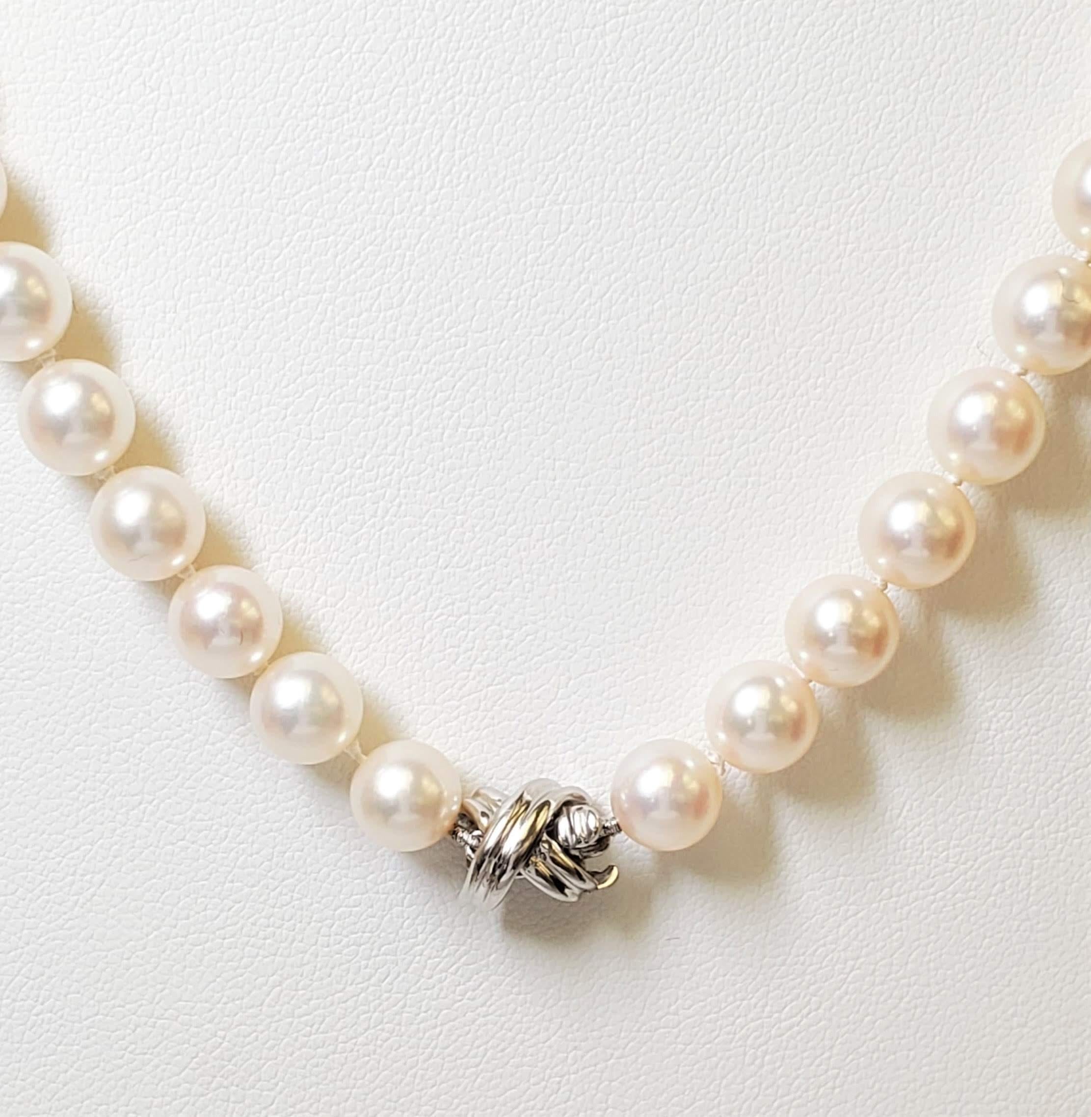 Classic Tiffany & Co. pearl necklace with platinum signature 'X' clasp. The pearls measure and estimated 7.4mm each and the necklace is 30 1/2 inches in length. Clasp is signed T&Co., PT950. The necklace is presented with original Tiffany folder, no