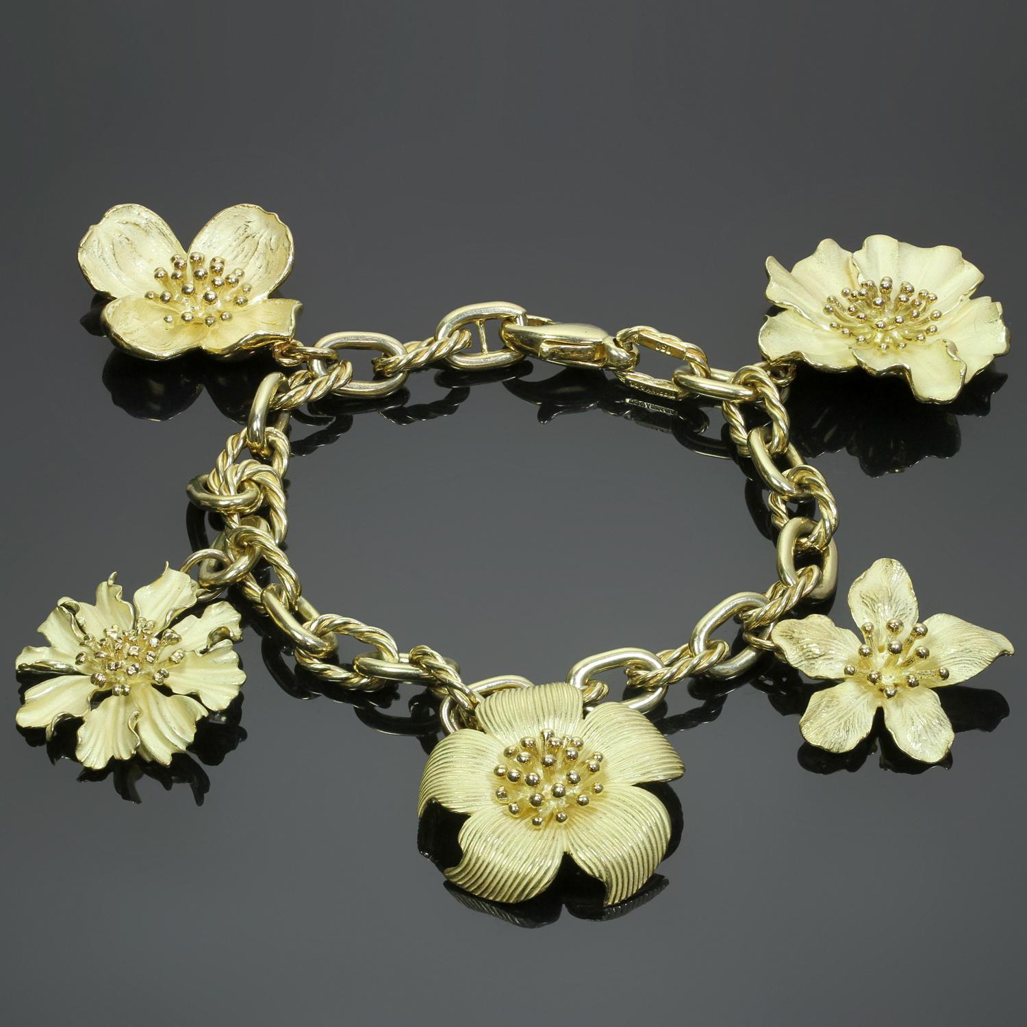 This rare Tiffany & Co. bracelet is crafted in 18k yellow gold and features a fabulous array of 5 Perennial Dogwood flower charms measuring 21.0mm to 26.0mm in length. Made in United States circa 2000s. Measurements: 7.5