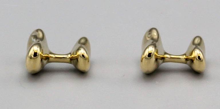 Fine pair of contemporary 18K yellow gold bean shaped cufflinks by Elsa Peretti for Tiffany & Co. circa 2000s. Current model is 18mm wide and retails for $4900, whereas this model is a smaller 15mm wide, just as handsome albeit of a smaller