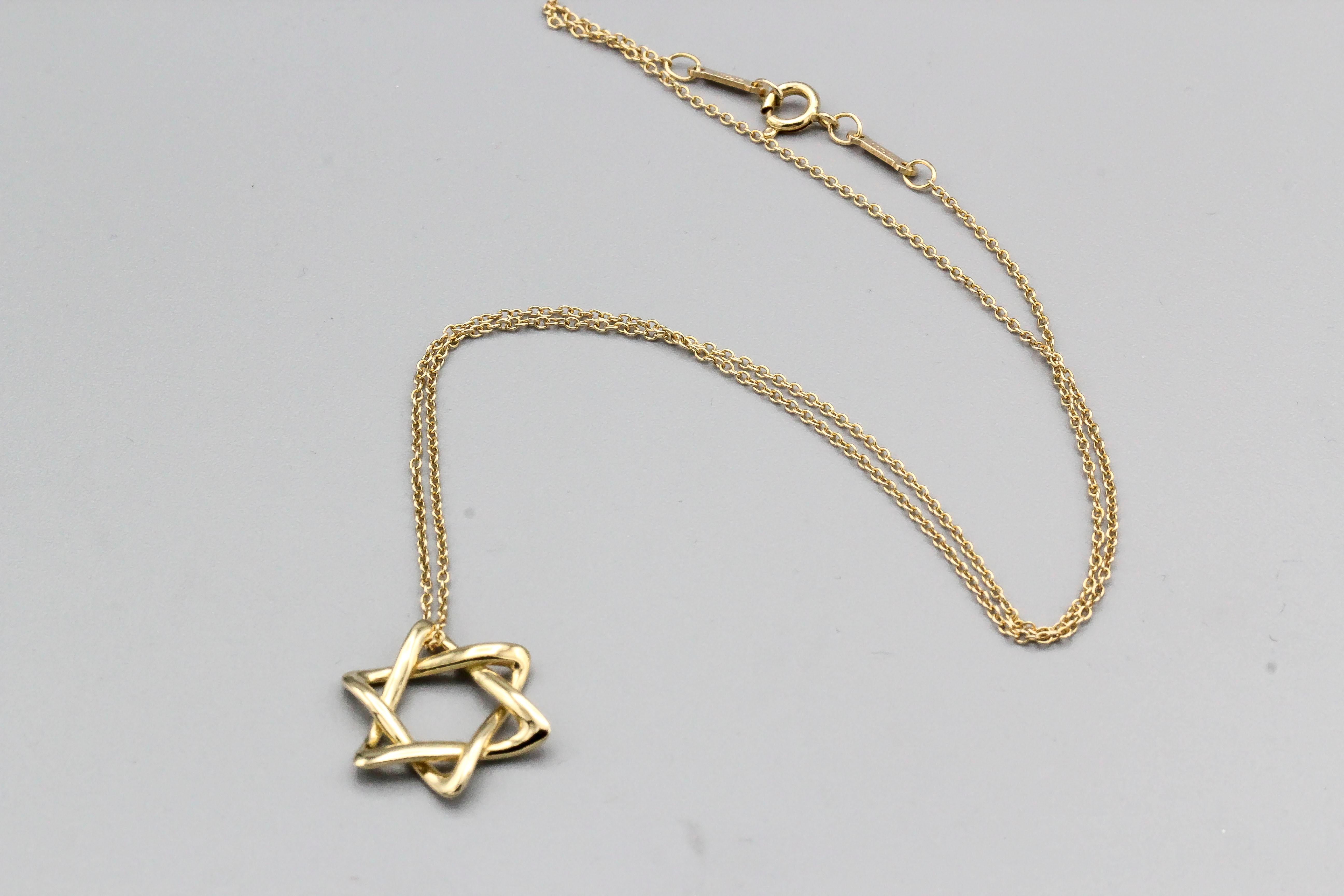 Fine 18K yellow gold David's Star necklace by Tiffany & Co., Elsa Peretti. This is the larger  of two sizes and currently retails for $1350. Chain length is 16