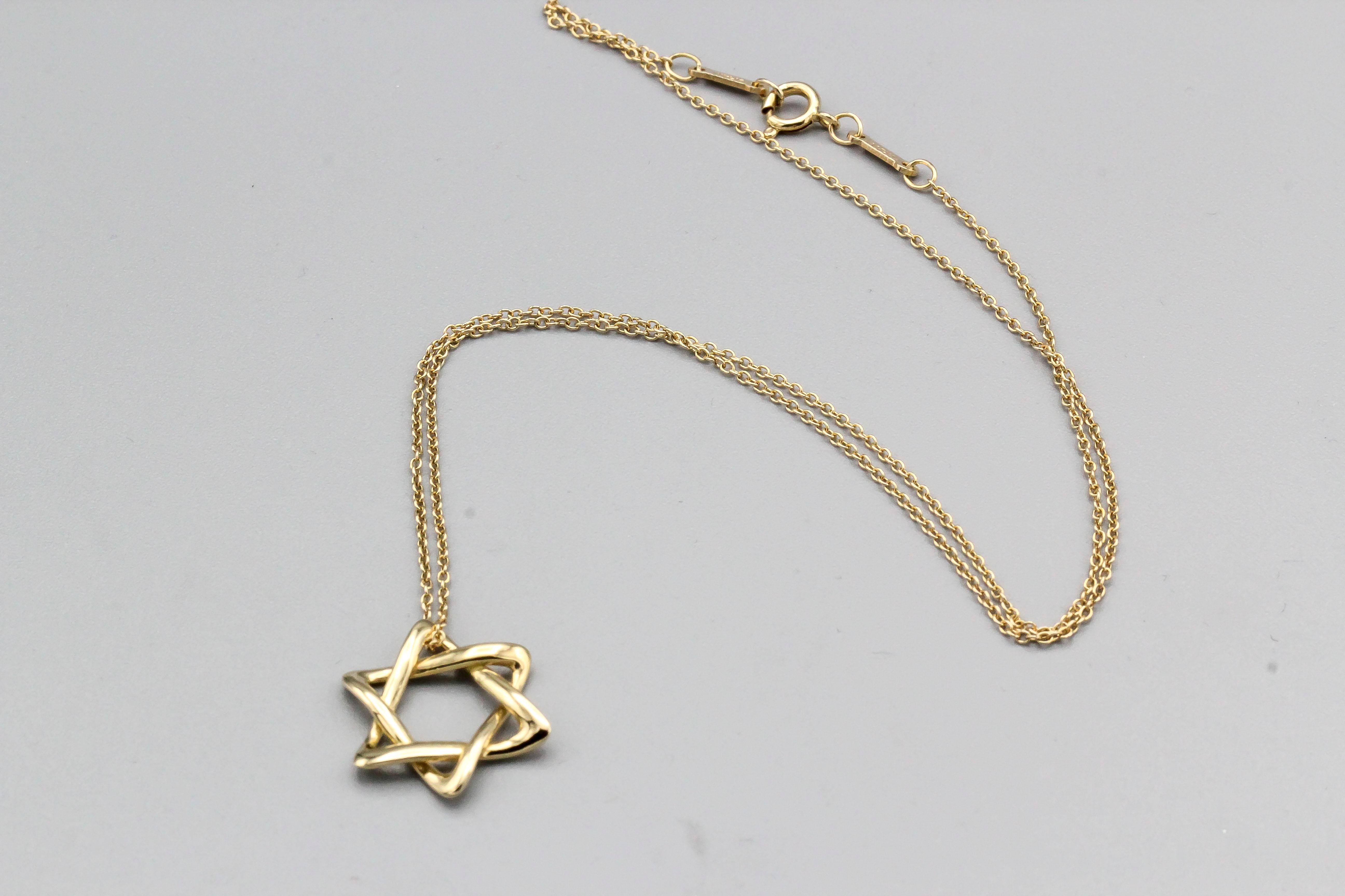 Elegant 18K yellow gold David's Star necklace by Tiffany & Co., Elsa Peretti. This is the larger  of two sizes and currently retails for $1150. Chain length is 16
