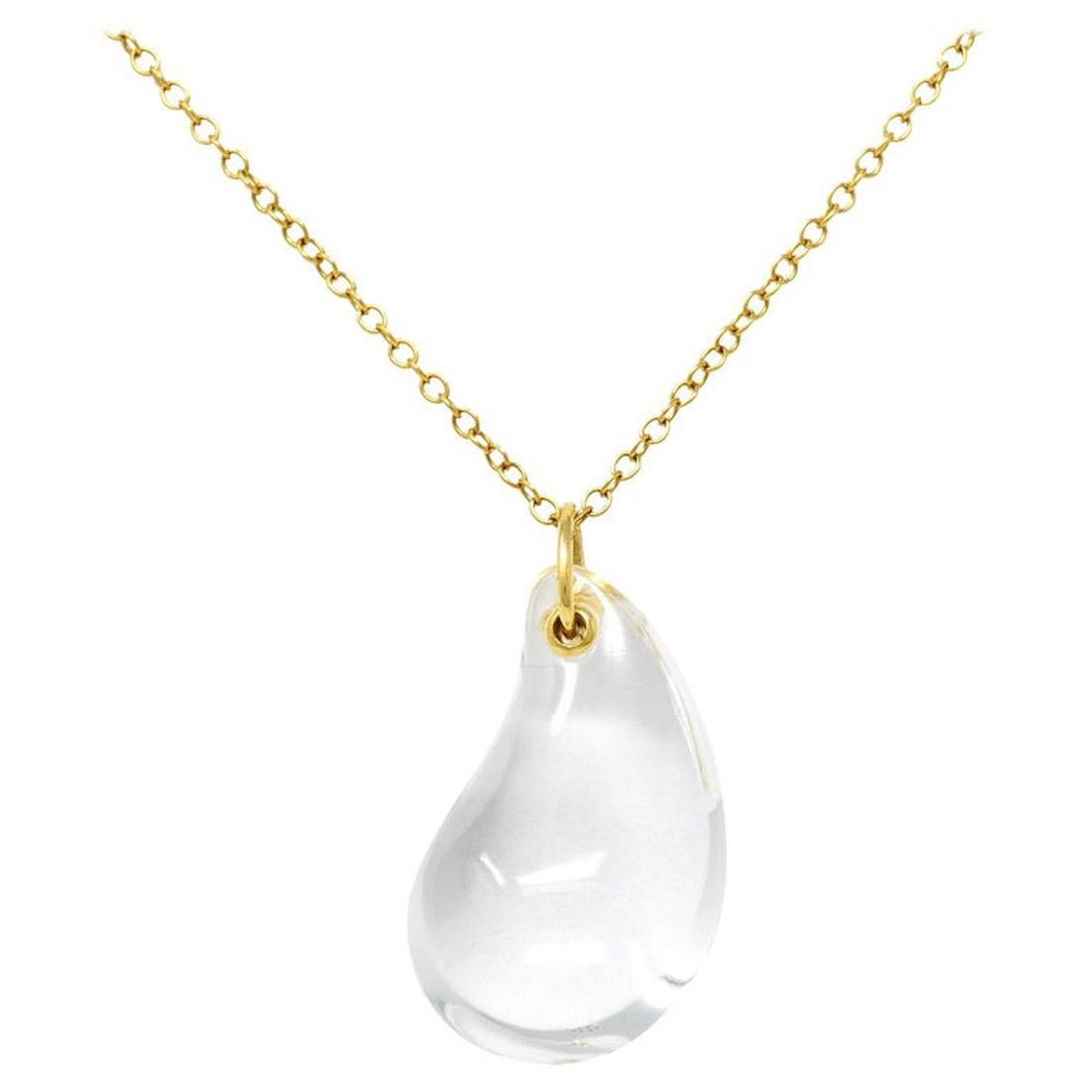 This elegant authentic necklace is from Tiffany & Co. by Elsa Peretti from her Tear Drop collection. The pendant is a stunning clear rock crystal tear drop and comes with a classic 18k yellow gold chain. It is signed by the designer with the gold