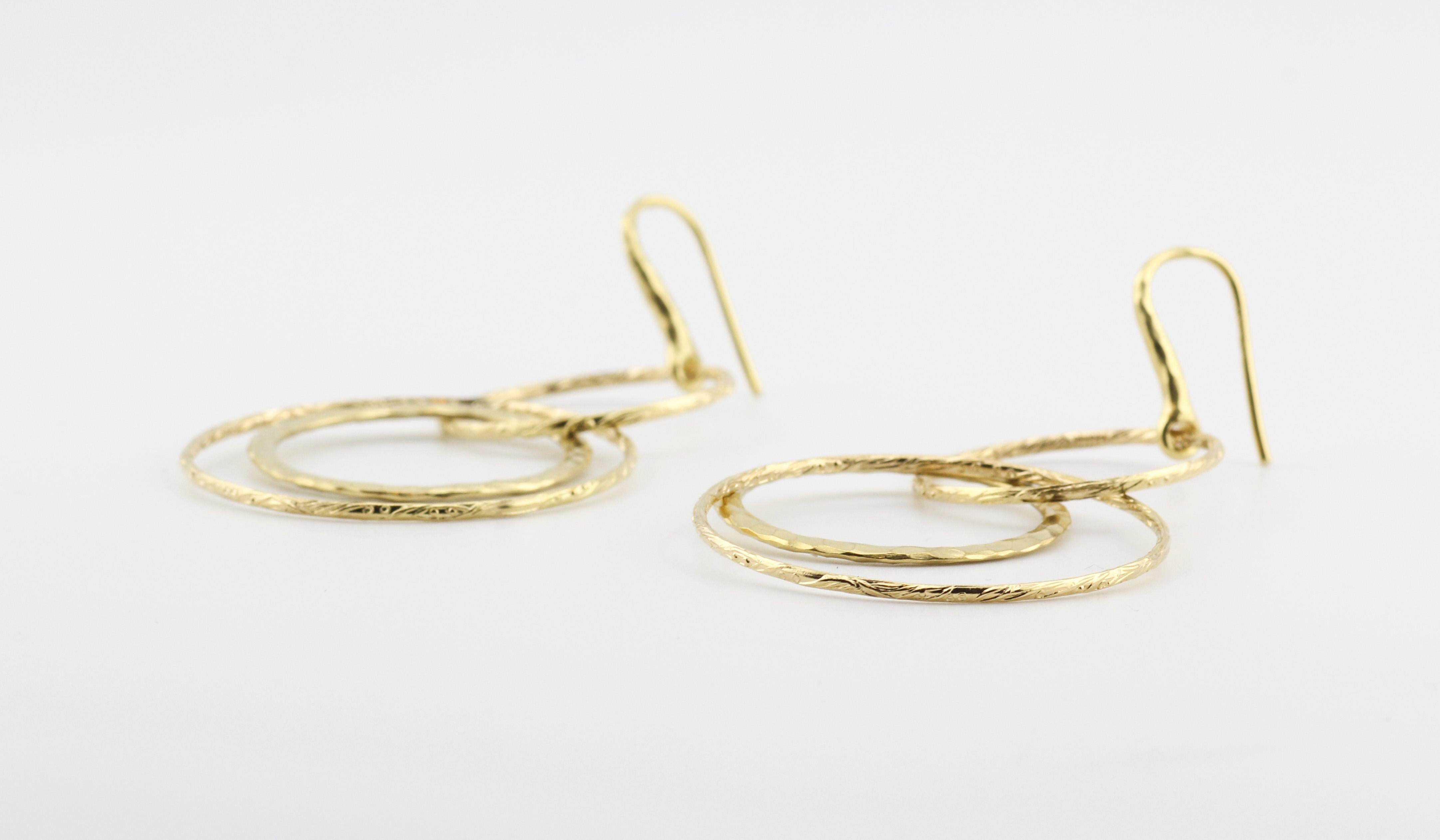 Enter the realm of artistic elegance with the Tiffany & Co. Picasso 18K Gold Hammered Circles Dangle Earrings—a stunning embodiment of creativity and craftsmanship. Crafted under the design influence of the renowned artist Pablo Picasso, these