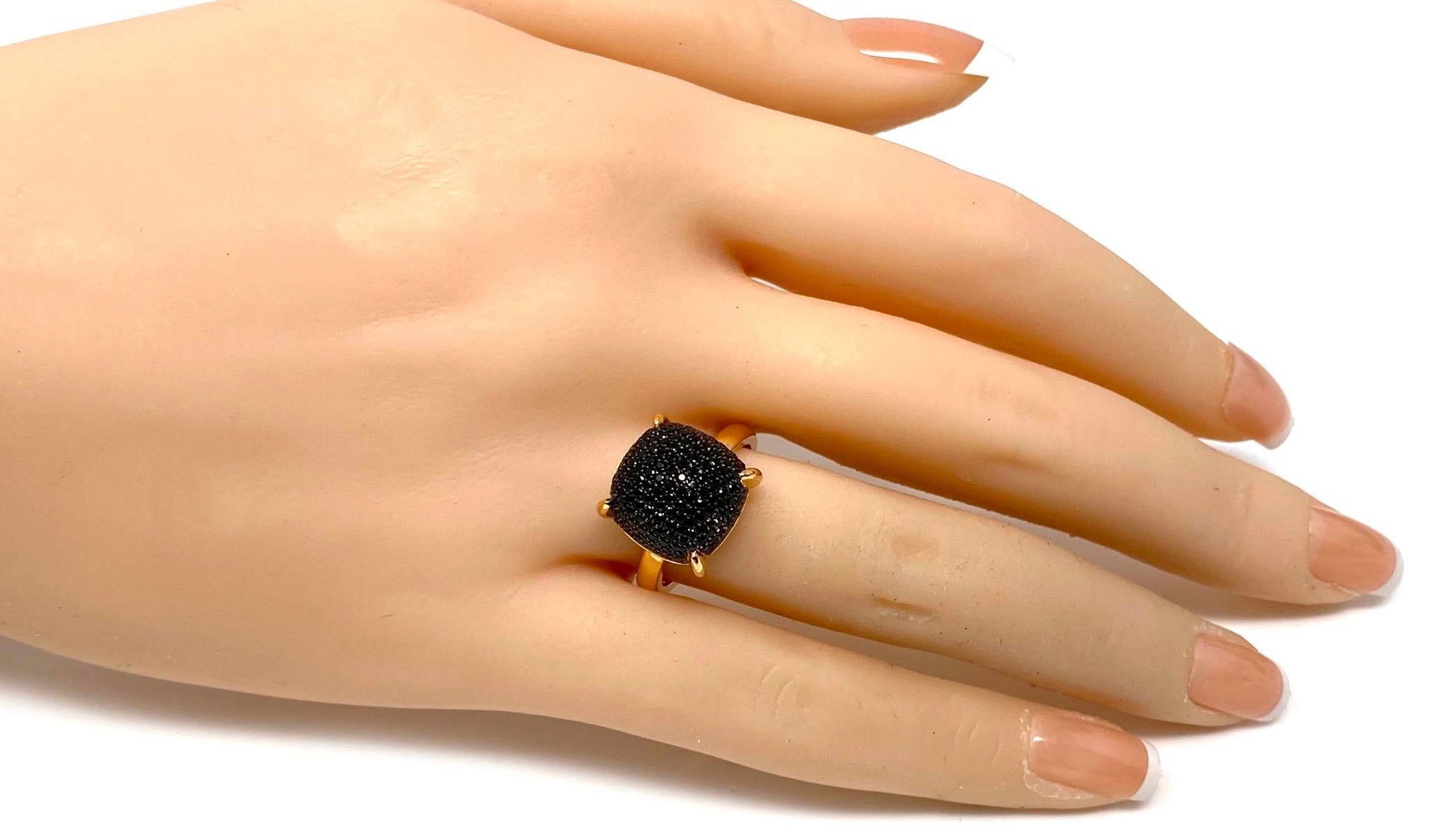 This elegant authentic ring is from Tiffany & Co. by designer Paloma Picasso from her Sugar Stacks collection. It is crafted from 18k rose gold with a polished finish. The ring has a large size cushion shape form with a dome top set with pave black
