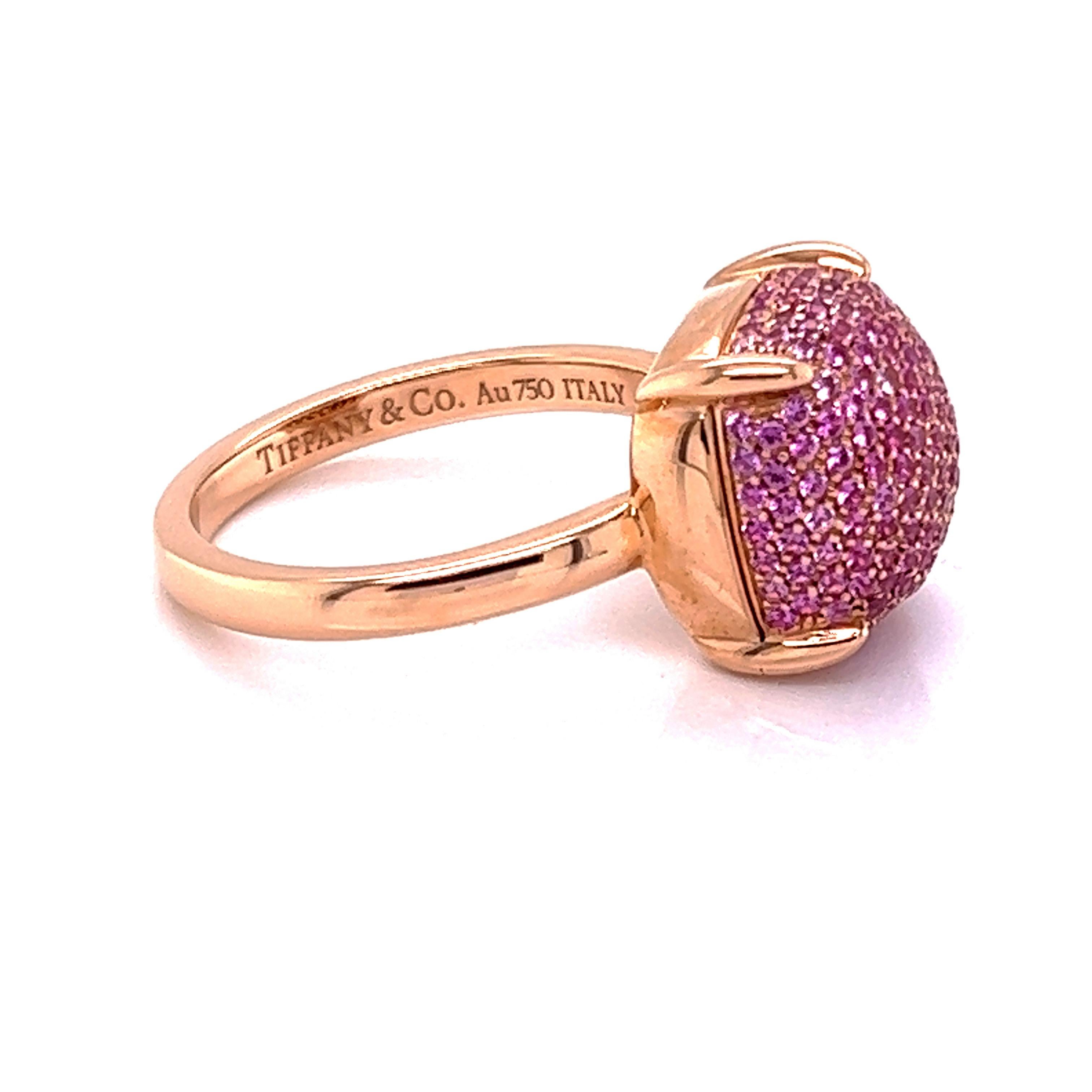 This is a beautiful authentic ring from Tiffany & Co. by designer Paloma Picasso from her Sugar Stacks Collection. It is crafted from 18k rose gold with a polished finish. The top of the ring has a cushion shape bridge with a high dome set with