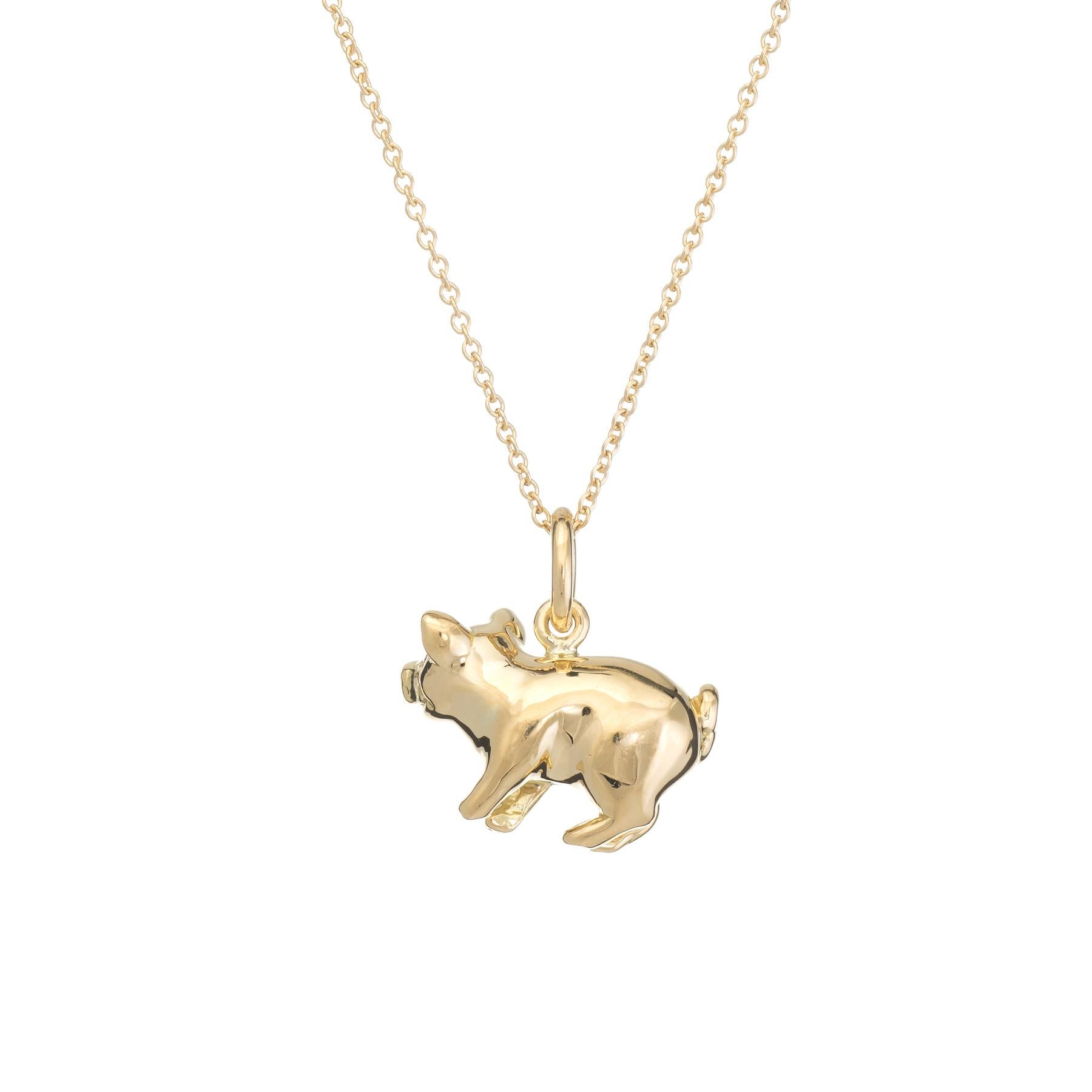 Finely detailed Tiffany & Co pig charm, crafted in 18 karat yellow gold.  

Two diamonds are embedded into the eyes and total an estimated 0.02 carats (estimated at F-G color and VVS2 clarity). 

Tiffany & Co necklace included (measures 16
