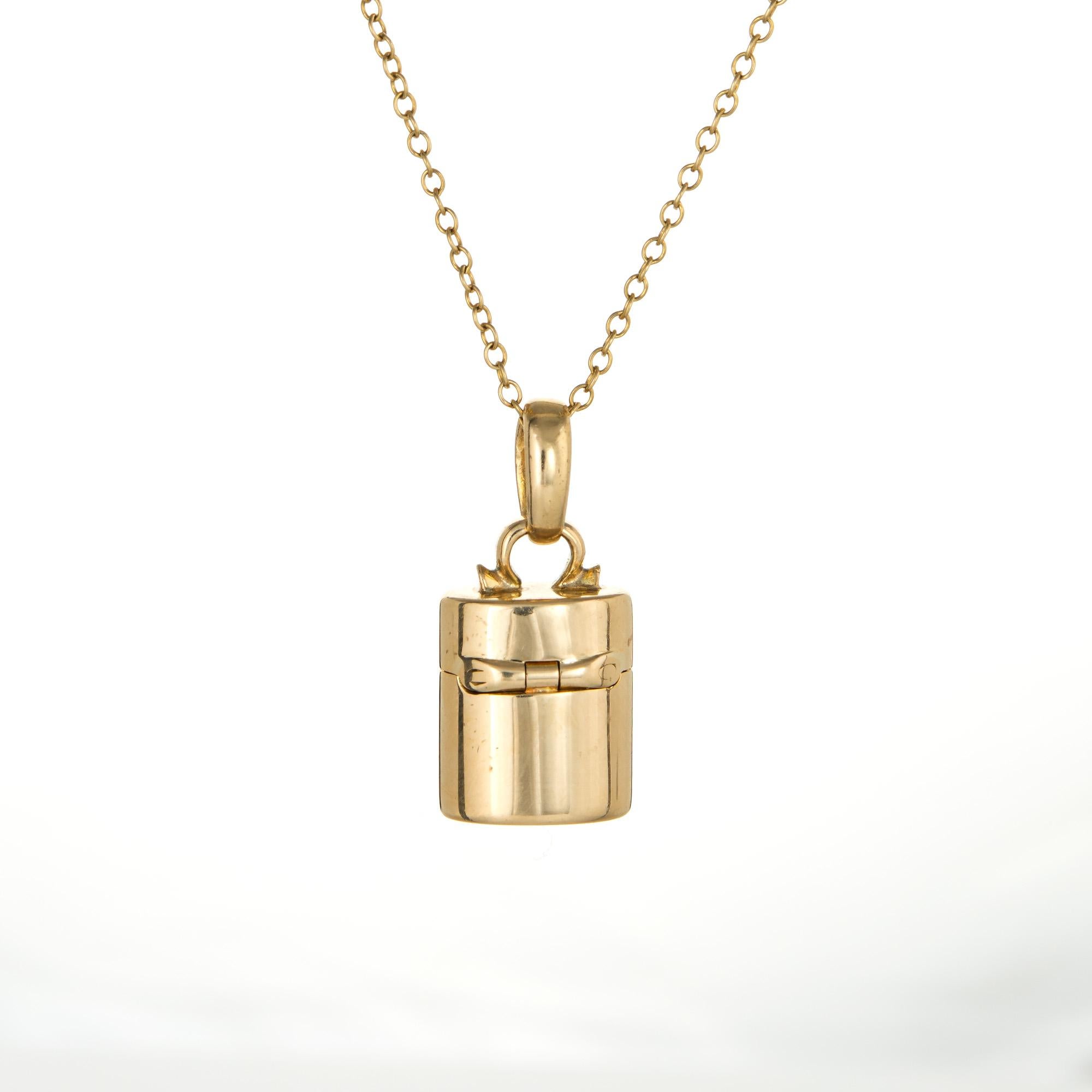Elegant and finely detailed vintage Tiffany & Co pillbox pendant & necklace crafted in 18 karat yellow gold.  

Sapphire cabochon is estimated at 0.10 carats (in excellent condition and free of cracks of chips).  

The pendant is a retired piece and