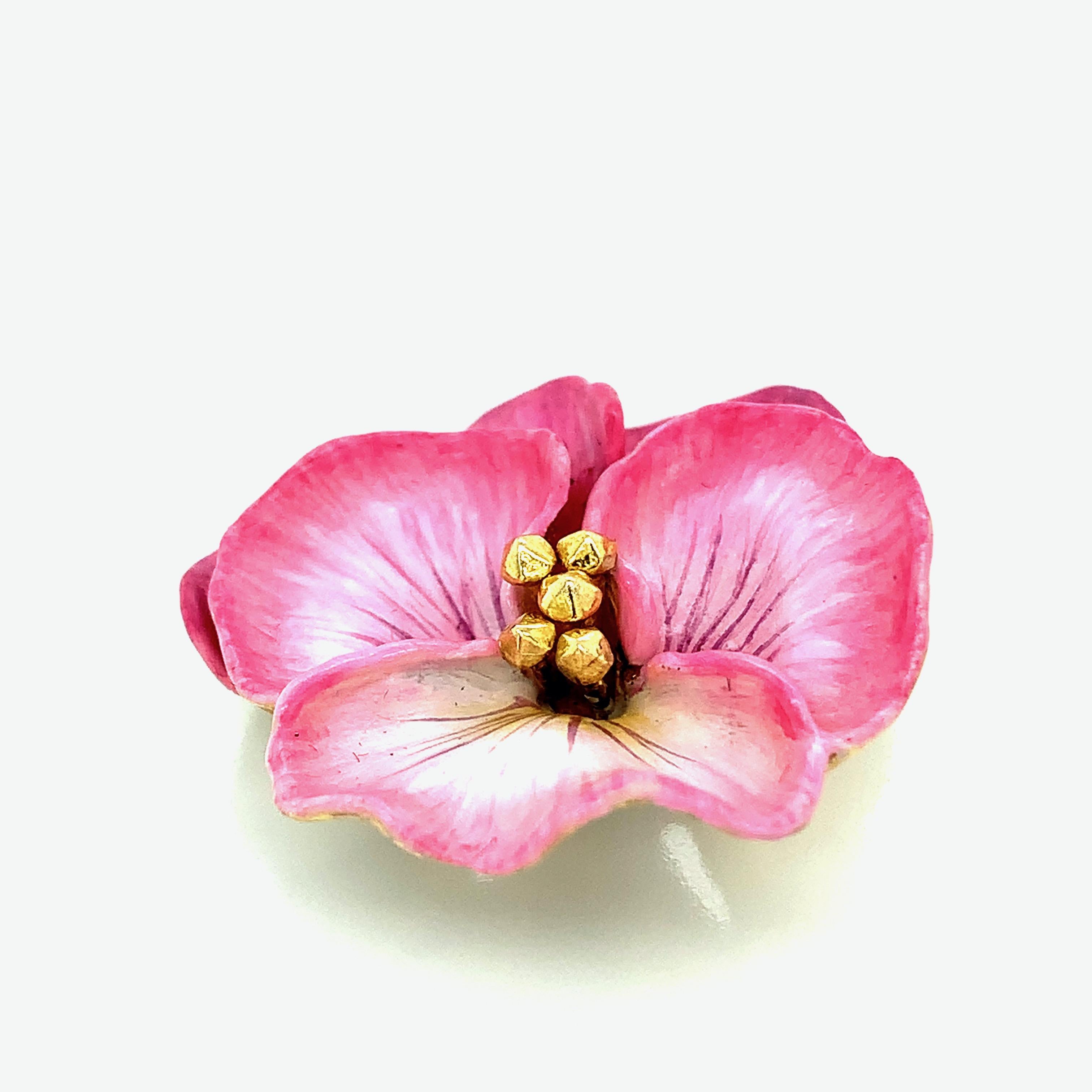 Tiffany & Co. 18 karat yellow gold brooch with a pink pansy design. Circa 1950s. Marked: Tiffany & Co. / K18. Total weight: 14.1 grams. Width: 3 cm. Length: 3.2 cm. 