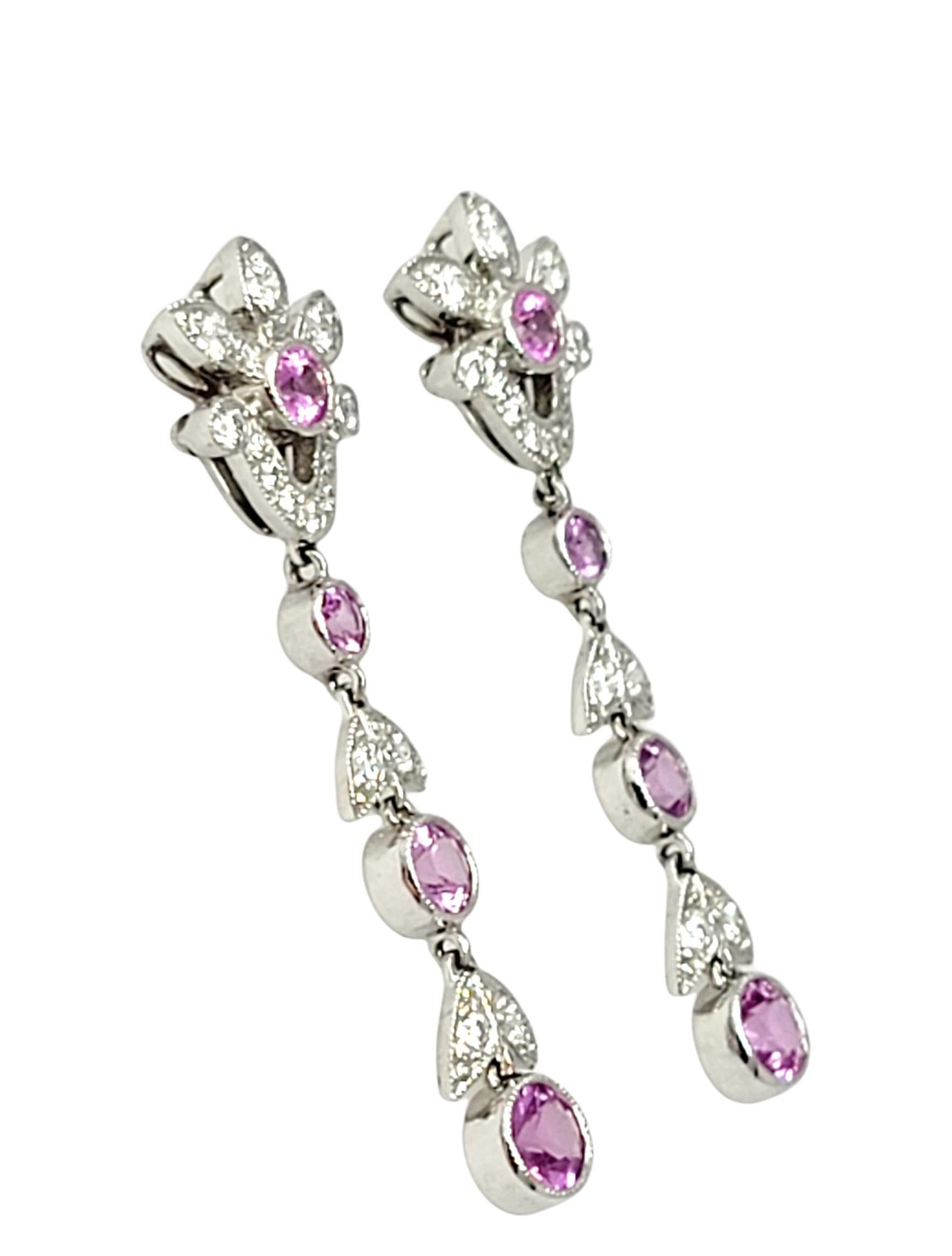 Gorgeous natural pink sapphire and diamond dangle earrings by Tiffany & Co.. These elegant, romantic earrings feature an embellished floral motif with milgrain detailing throughout. The gentle movement catches the light and sparkles beautifully on