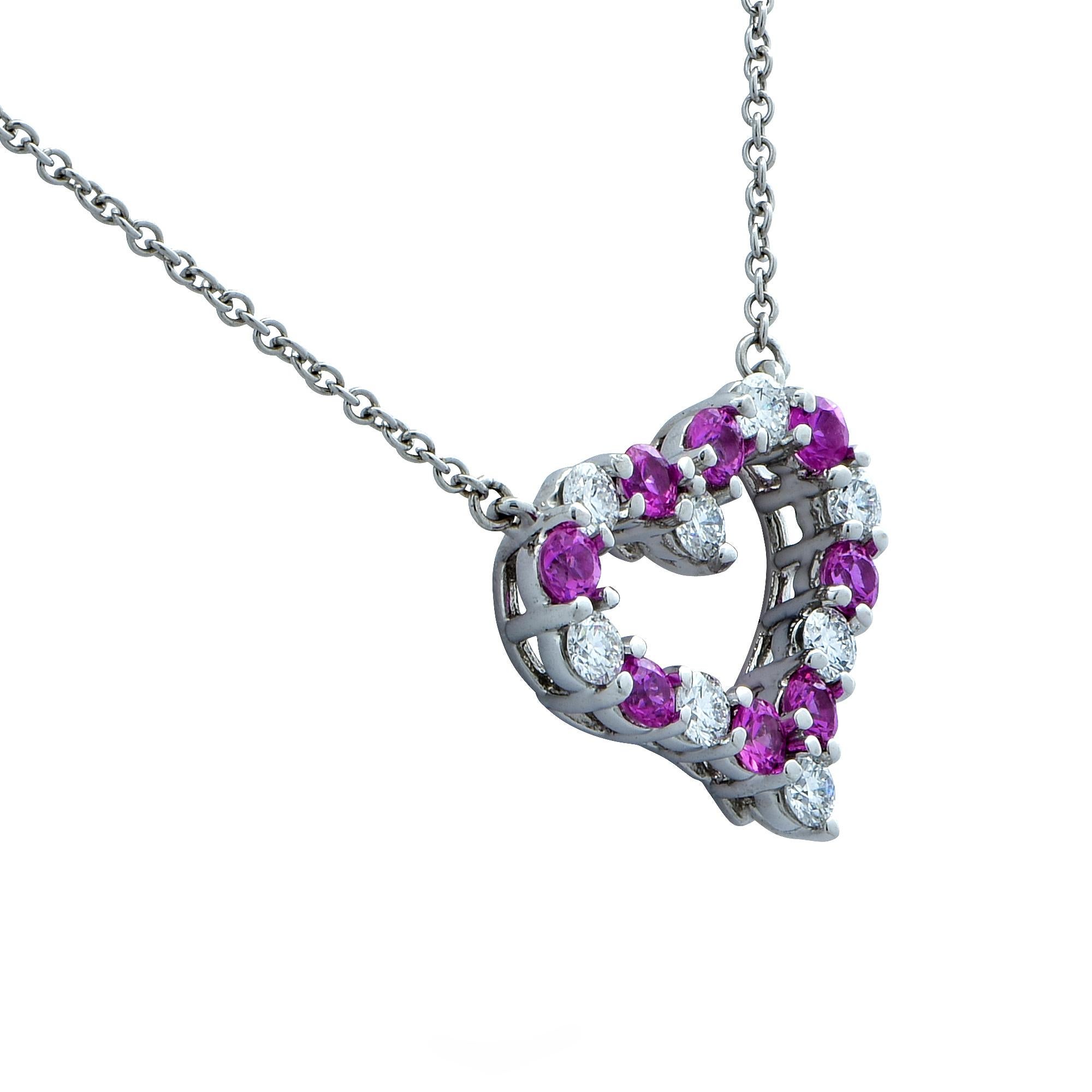 Tiffany & Co. pink sapphire and diamond heart necklace crafted in platinum featuring 8 round brilliant cut diamonds weighing approximately .31cts total, F color, VS clarity accented by 8 pink sapphires weighing approximately .38cts total. The