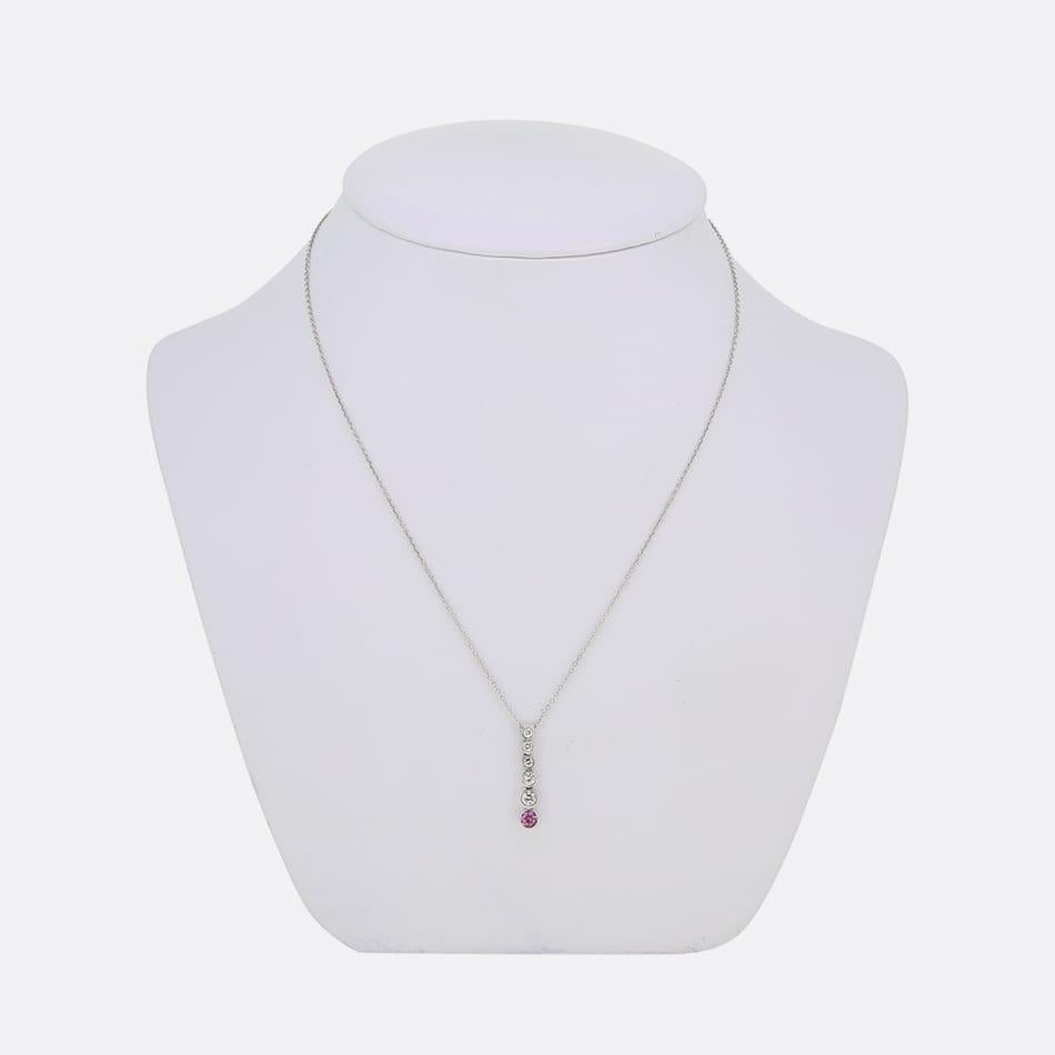 This is a platinum, pink sapphire and diamond drop necklace from the luxury jewellery designer Tiffany & Co. The necklace forms part of the jazz collection and plays host to 5 graduated round brilliant cut diamonds and a single pink