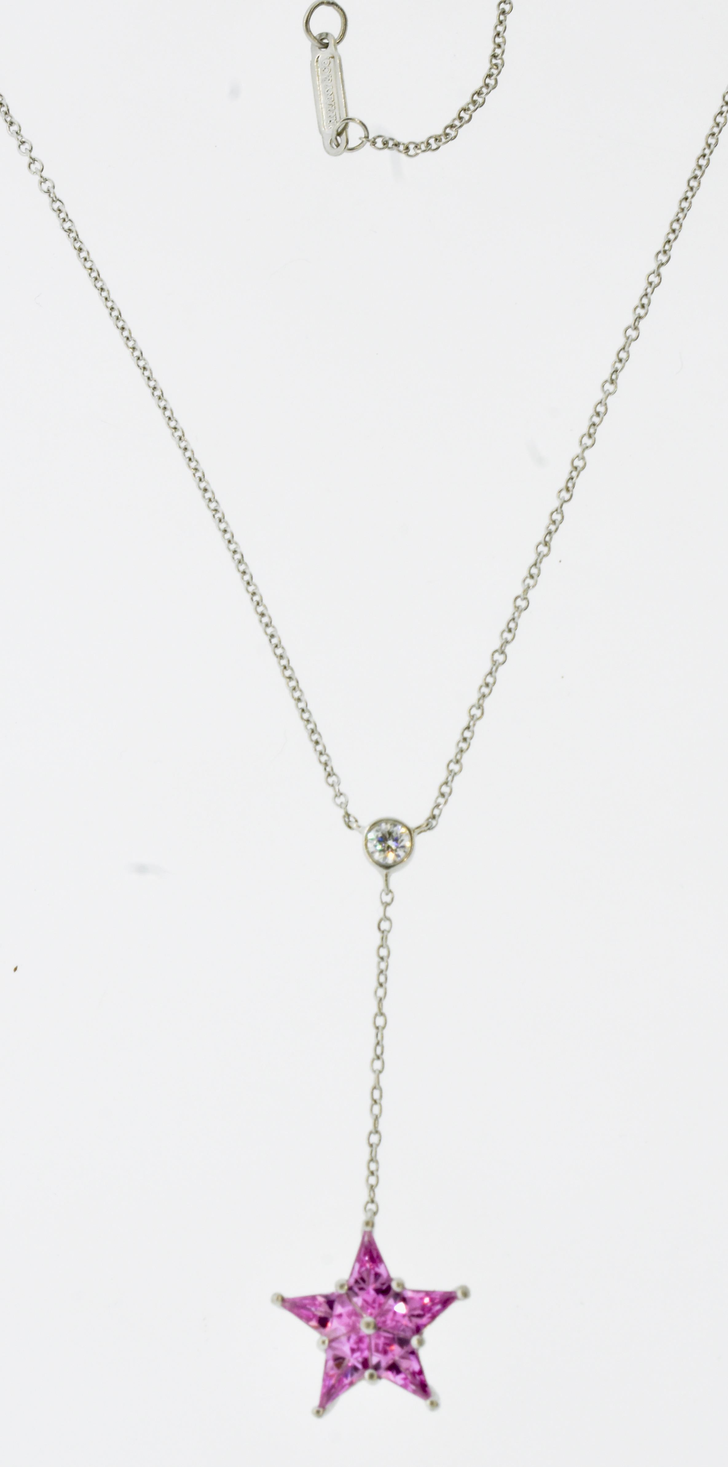Tiffany necklace terminating with a pendant of pink sapphires set in a star motif.  The platinum  star pendant is suspended from a fine, collet set diamond, weighing approximately .10 cts., near colorless, (G) and very slightly included (VS).  The 