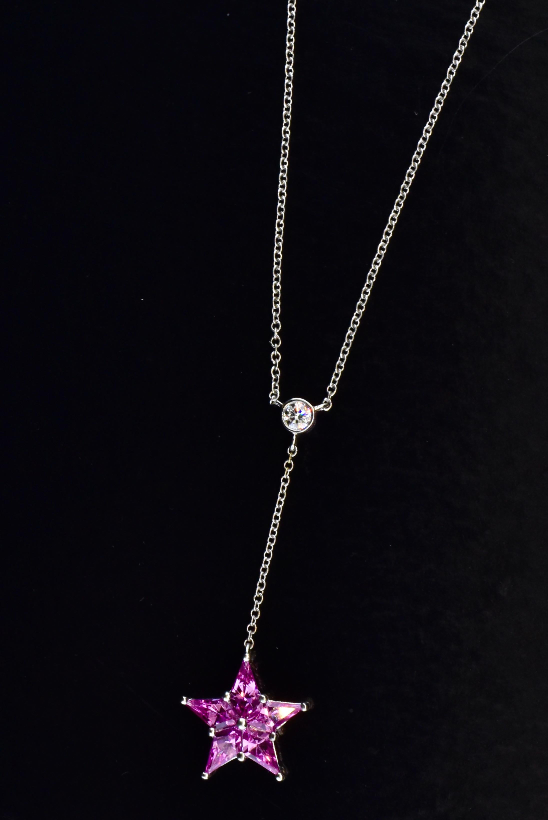 Tiffany necklace terminating with a pendant of pink sapphires set in a star motif.  The platinum  star pendant is suspended from a fine, collet set diamond, weighing approximately .10 cts., near colorless, (G) and very slightly included (VS).  The 