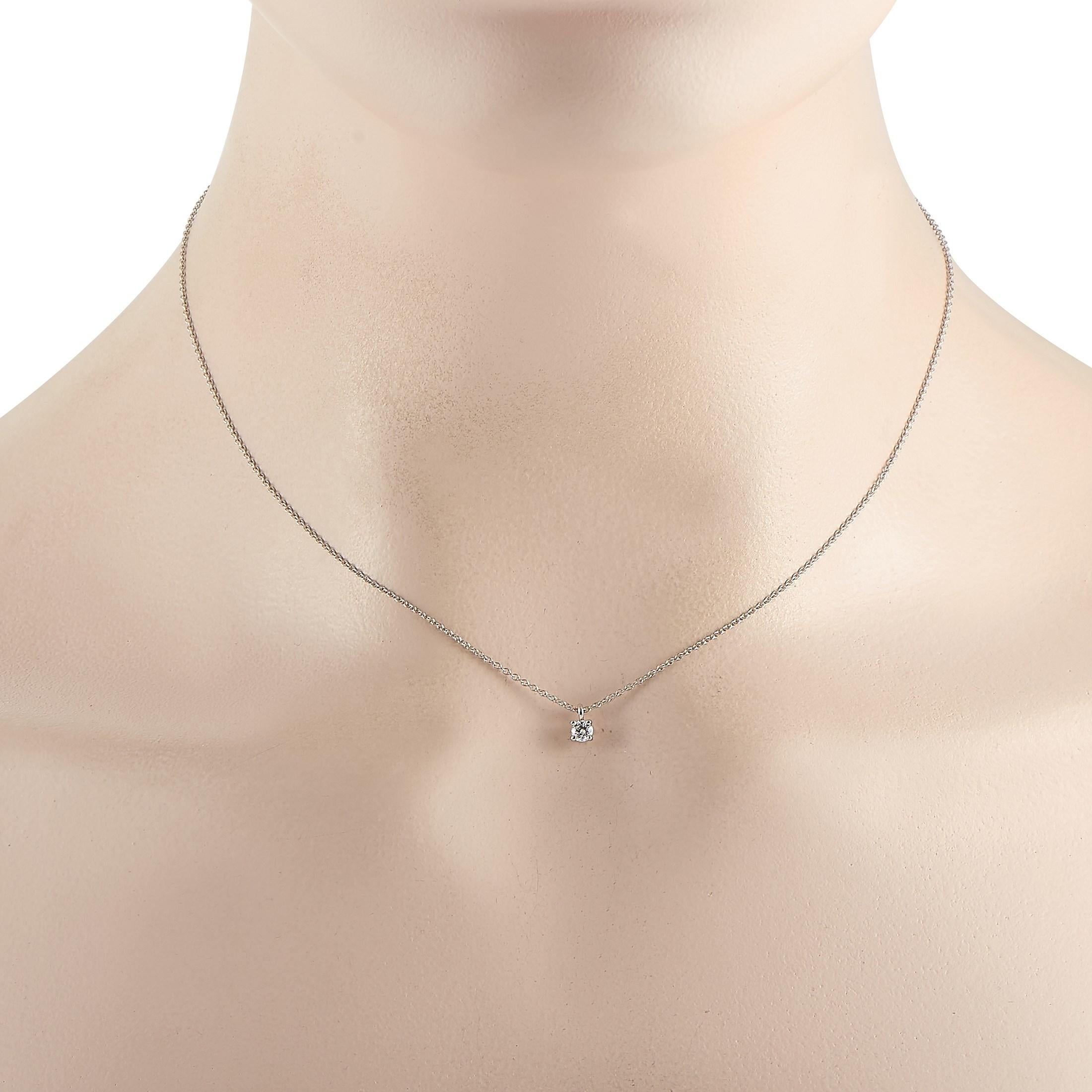 This classic Tiffany & Co. Platinum 0.15 ct Diamond Solitaire Necklace is made with Platinum and features a solitary 0.15 carat diamond pendant held in place by four prongs. The fine platinum chain measures 16 inches in length and features a