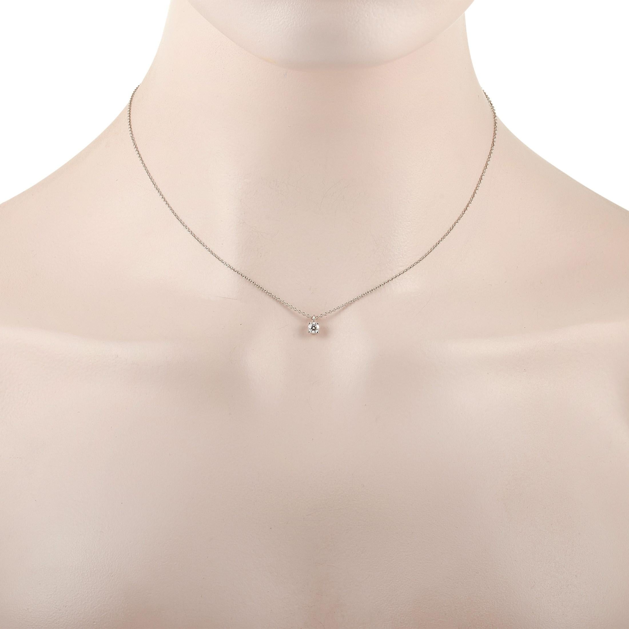 This classic Tiffany & Co. Platinum 0.15 ct Diamond necklace is made with Platinum and features a solitary 0.15 carat diamond pendant held in place by four prongs. The fine platinum chain measures 15 inches in length and features a spring-ring
