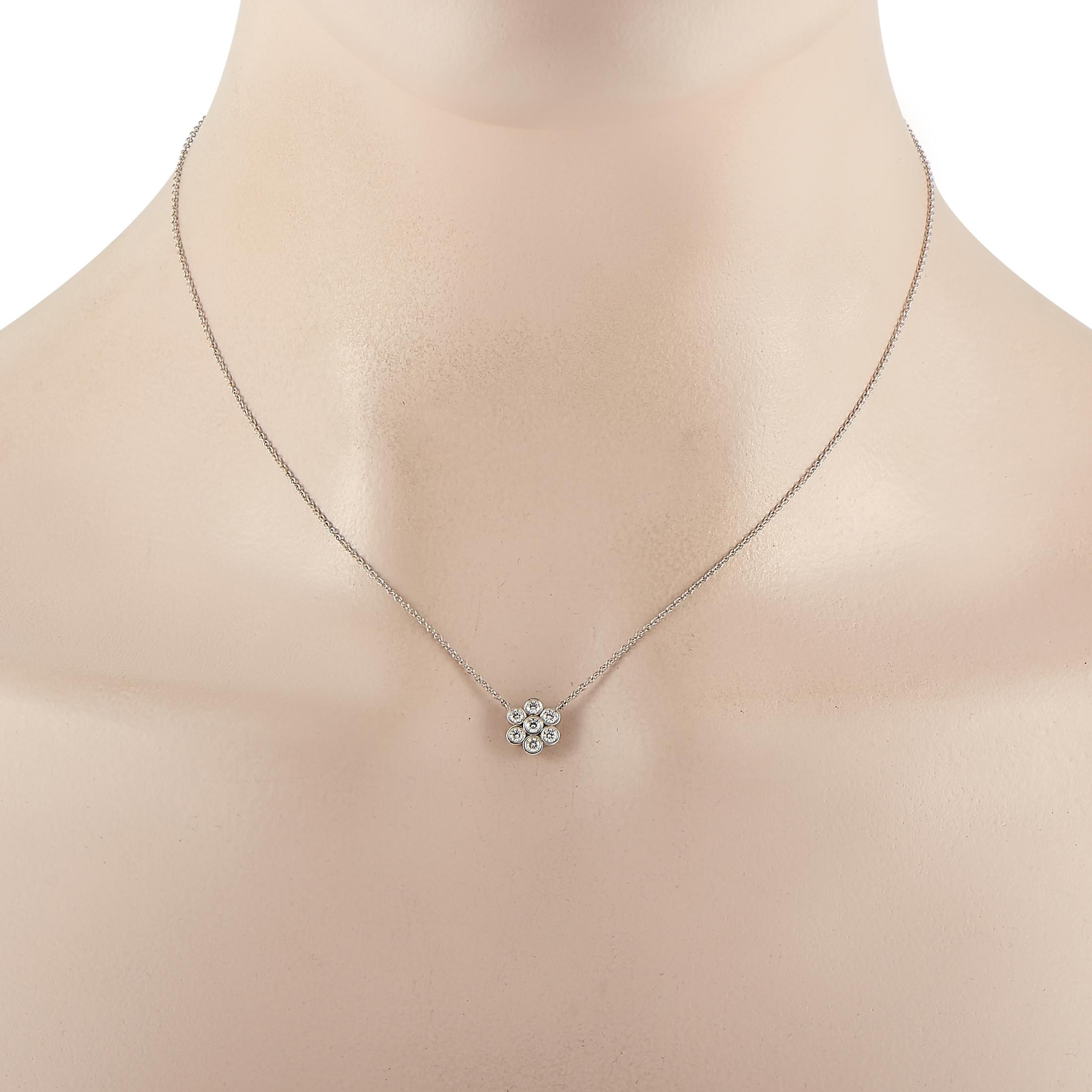 Displaying a flower-shaped cluster of bezel-set round diamonds, the Tiffany & Co. Platinum 0.25 Diamond Flower Necklace will effortlessly bring an elegant and feminine flair to your looks. The ultra-gorgeous and extremely sparkly pendant has seven