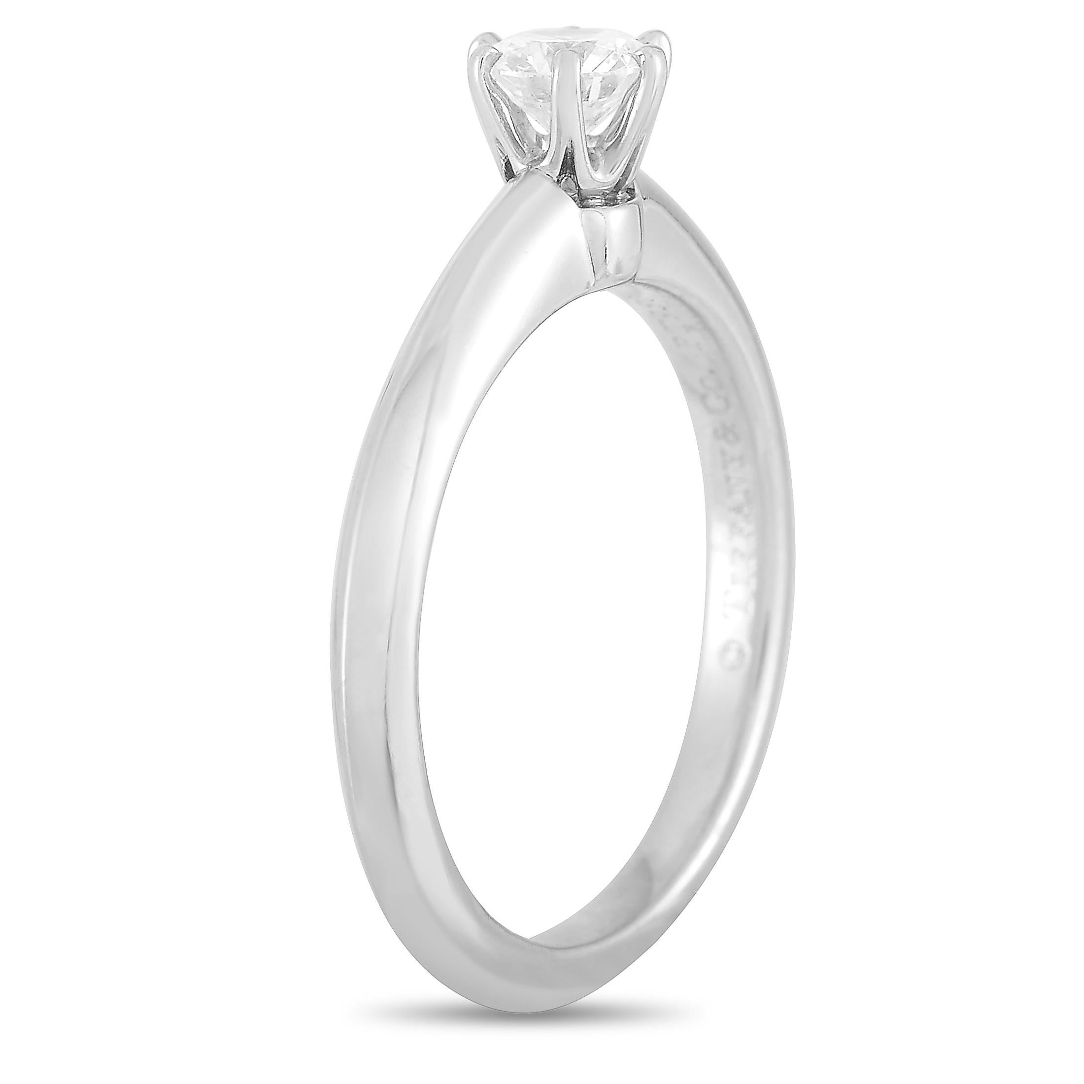 This Tiffany & Co. engagement ring is made of platinum and set with a diamond stone that features G color and VS1 clarity and weighs approximately 0.29 carats. The ring weighs 3.6 grams and boasts band thickness of 2 mm and top height of 6 mm, while